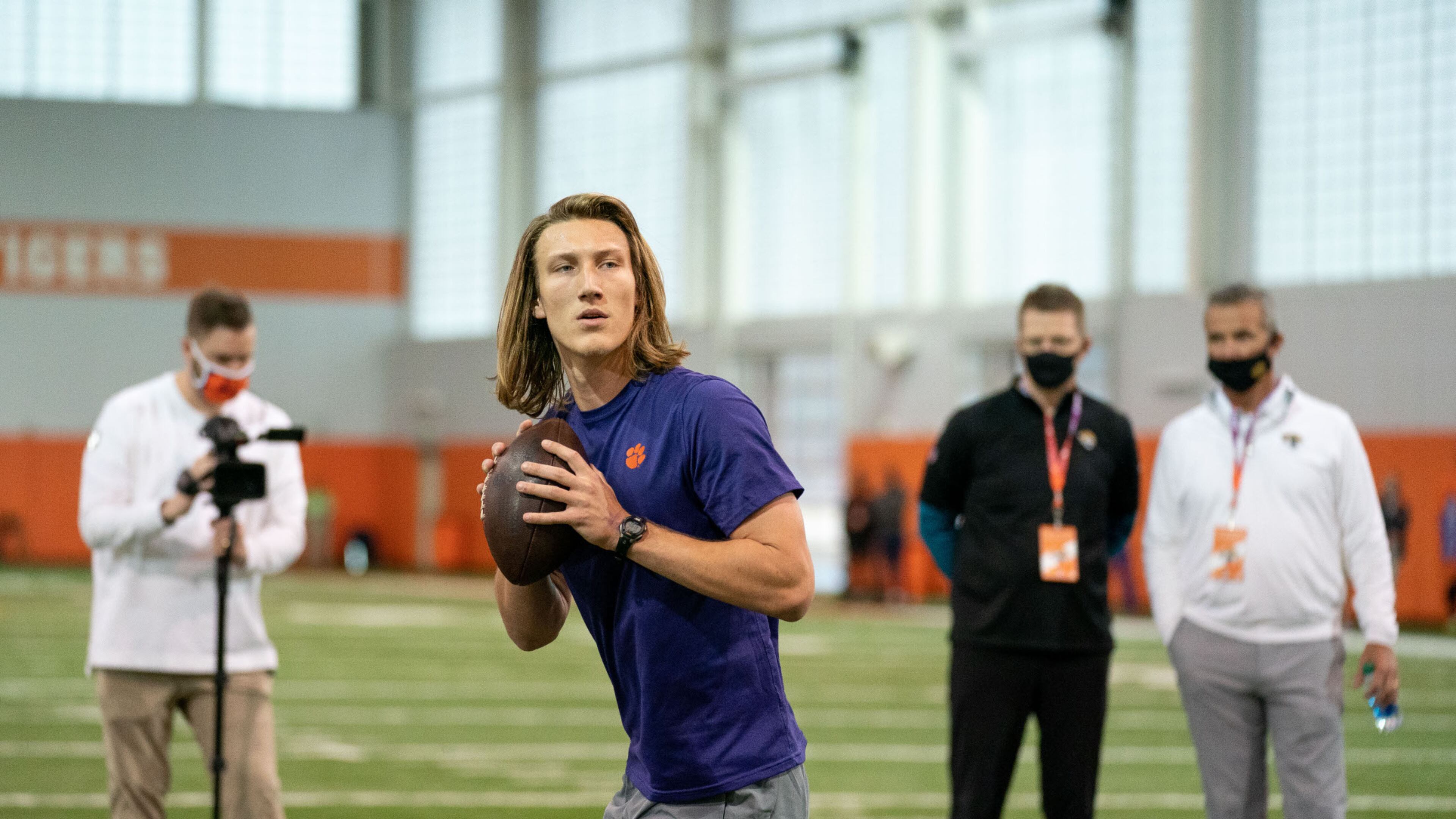 Former Clemson quarterback Trevor Lawrence warming up under the watchful eye of Jacksonville coach Urban Meyer in the background. (Photo courtesy of David Platt/Clemson Athletics)