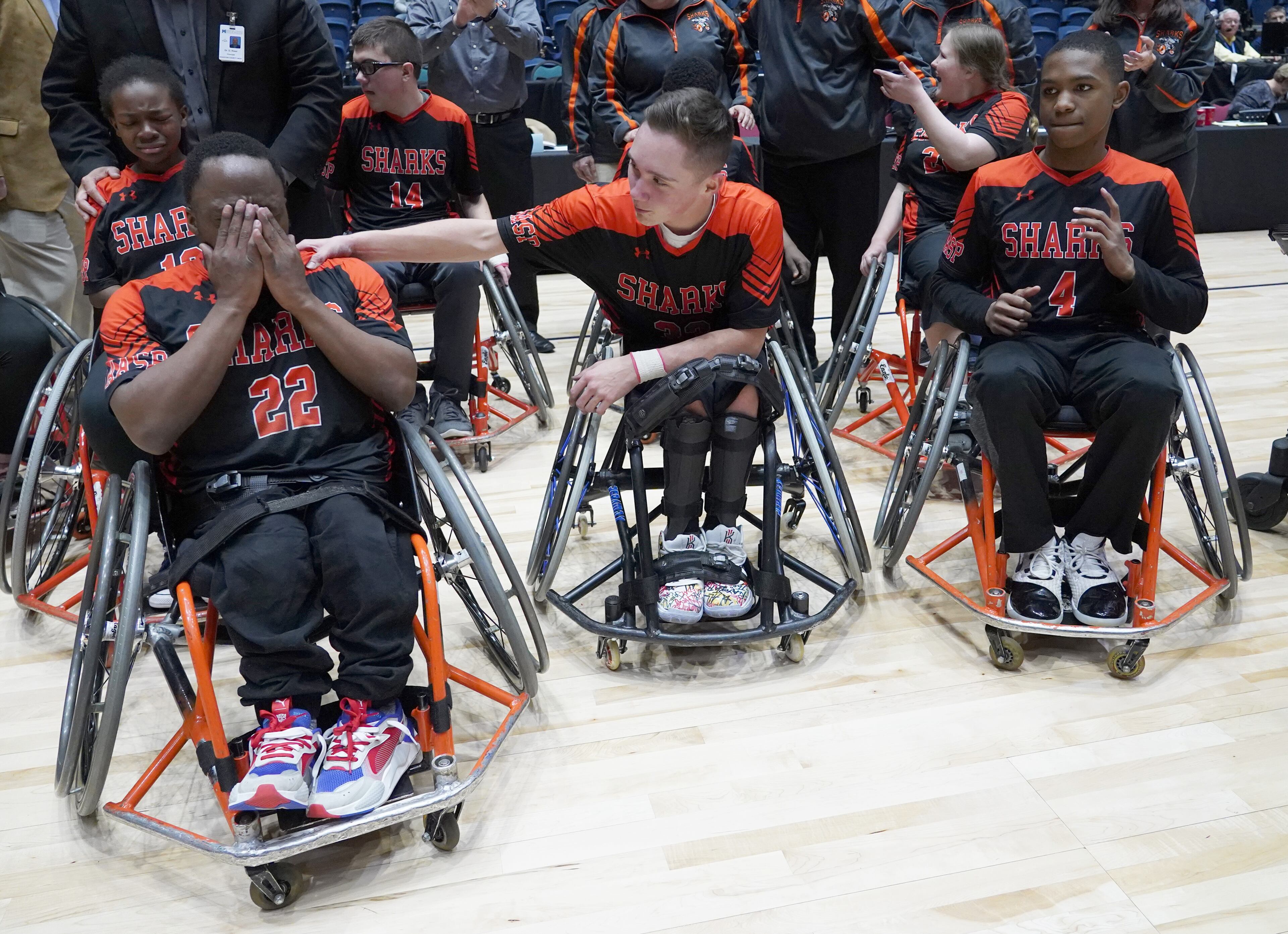 O'lando Hicks (left) cries as teammates Dylan Thompson (center) reaches out after the Houston Sharks defeated the Henry Hurricanes for the GHSA wheelchair state title game at the Macon Centreplex, Friday March 6, 2020, in Macon. Tami Chappell for the Atlanta Journal Constitution