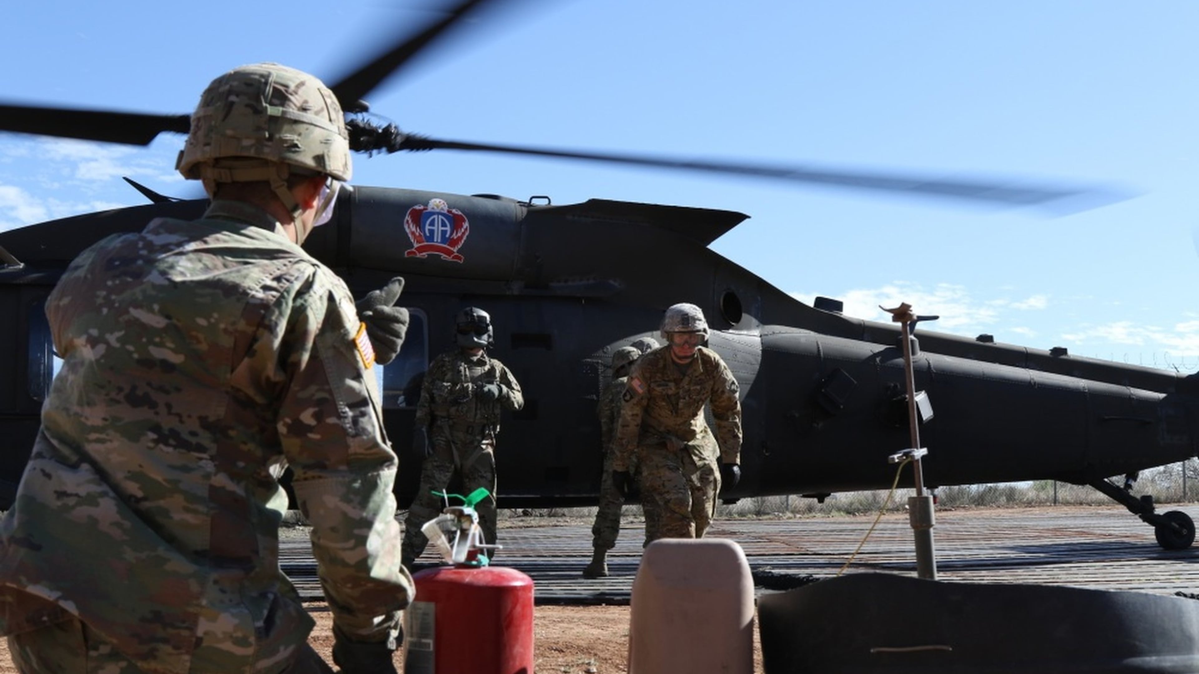 Soldiers from 227th Composite Supply Company, 101st Airborne Division, rush to refuel a Blackhawk helicopter in between missions in Sasabe, Ariz., on Nov. 20.