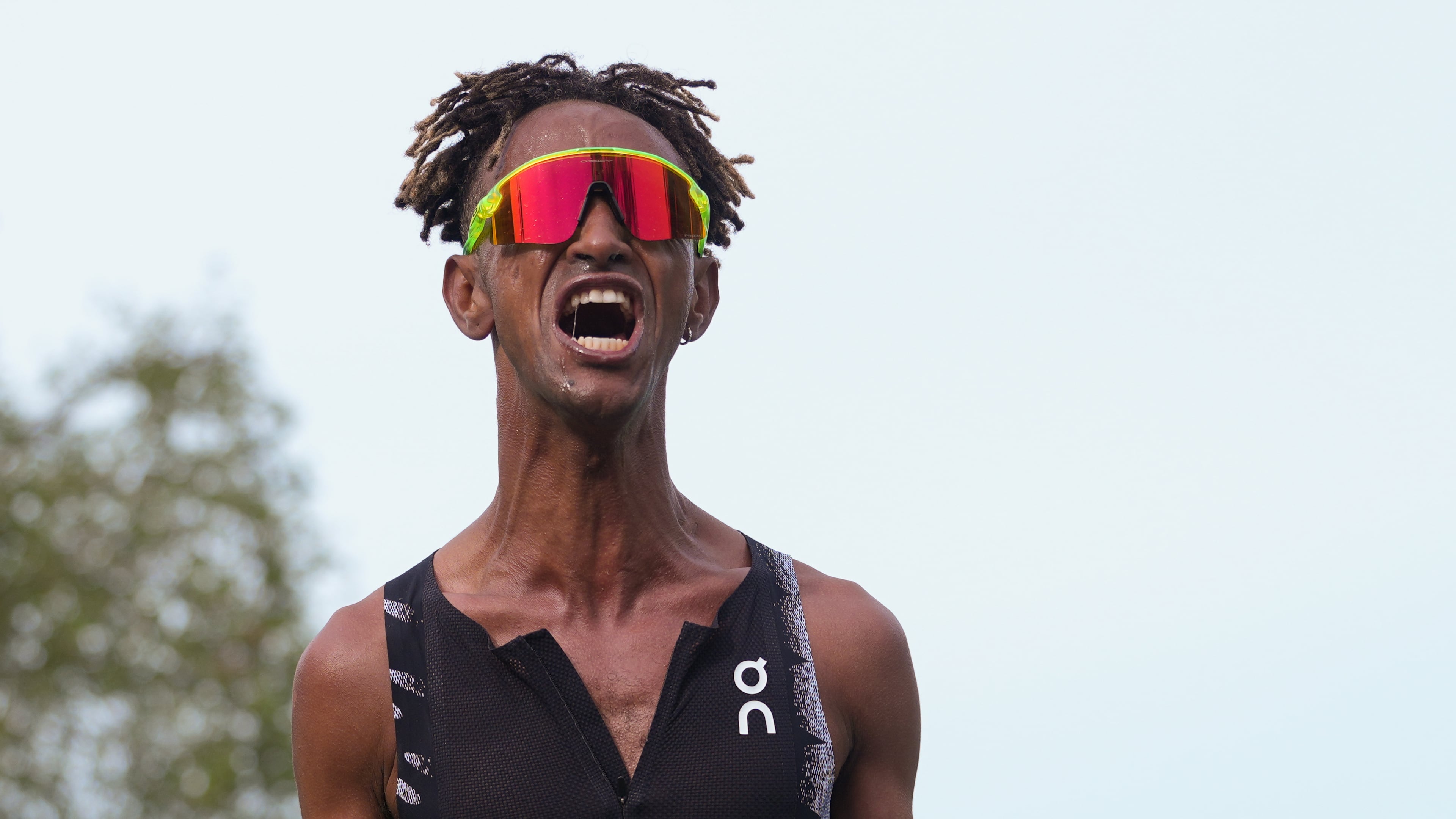 Italy's Yemaneberhan Crippa celebrates after crossing the finish line to win the men's race of the Paris marathon, in Paris, Sunday, April 12, 2026. (AP Photo/Thibault Camus)