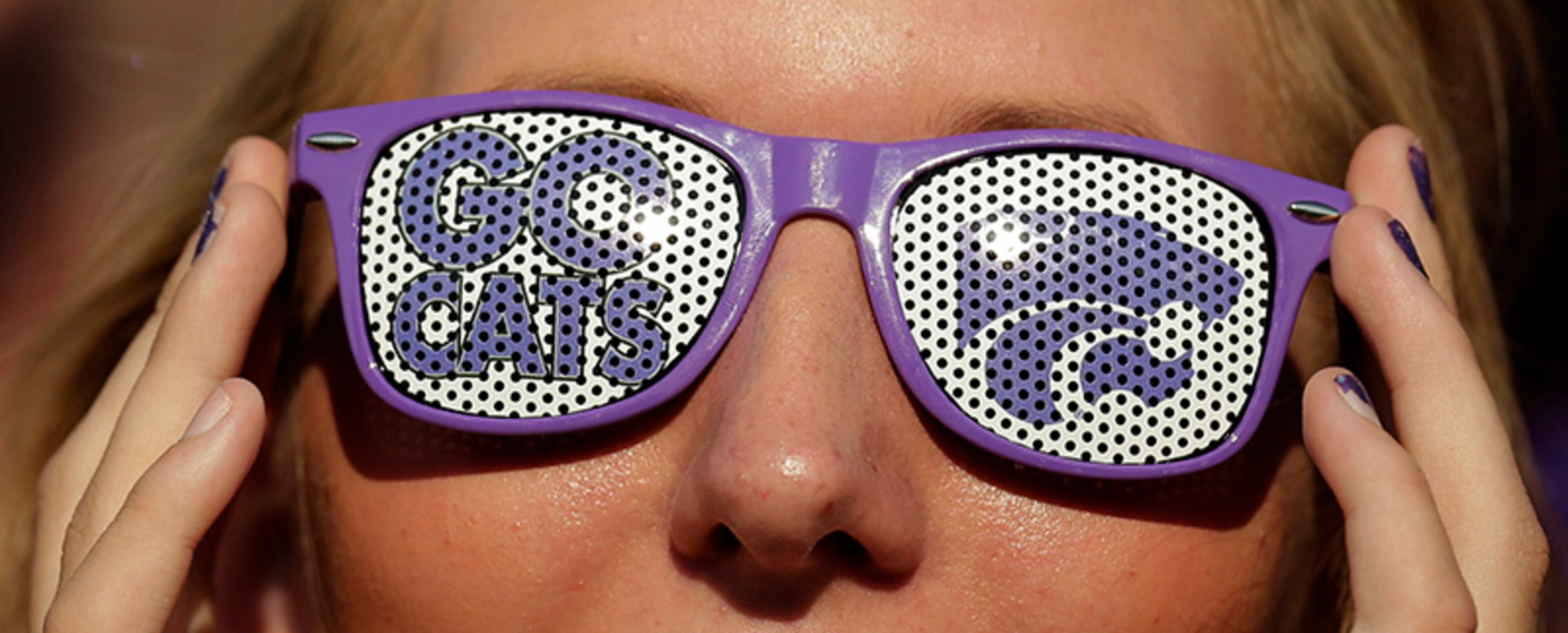 A Kansas State fan watches the action during the first half of an NCAA college football game between Kansas State and the Louisiana-Lafayette Saturday, Sept. 7, 2013, in Manhattan, Kan.