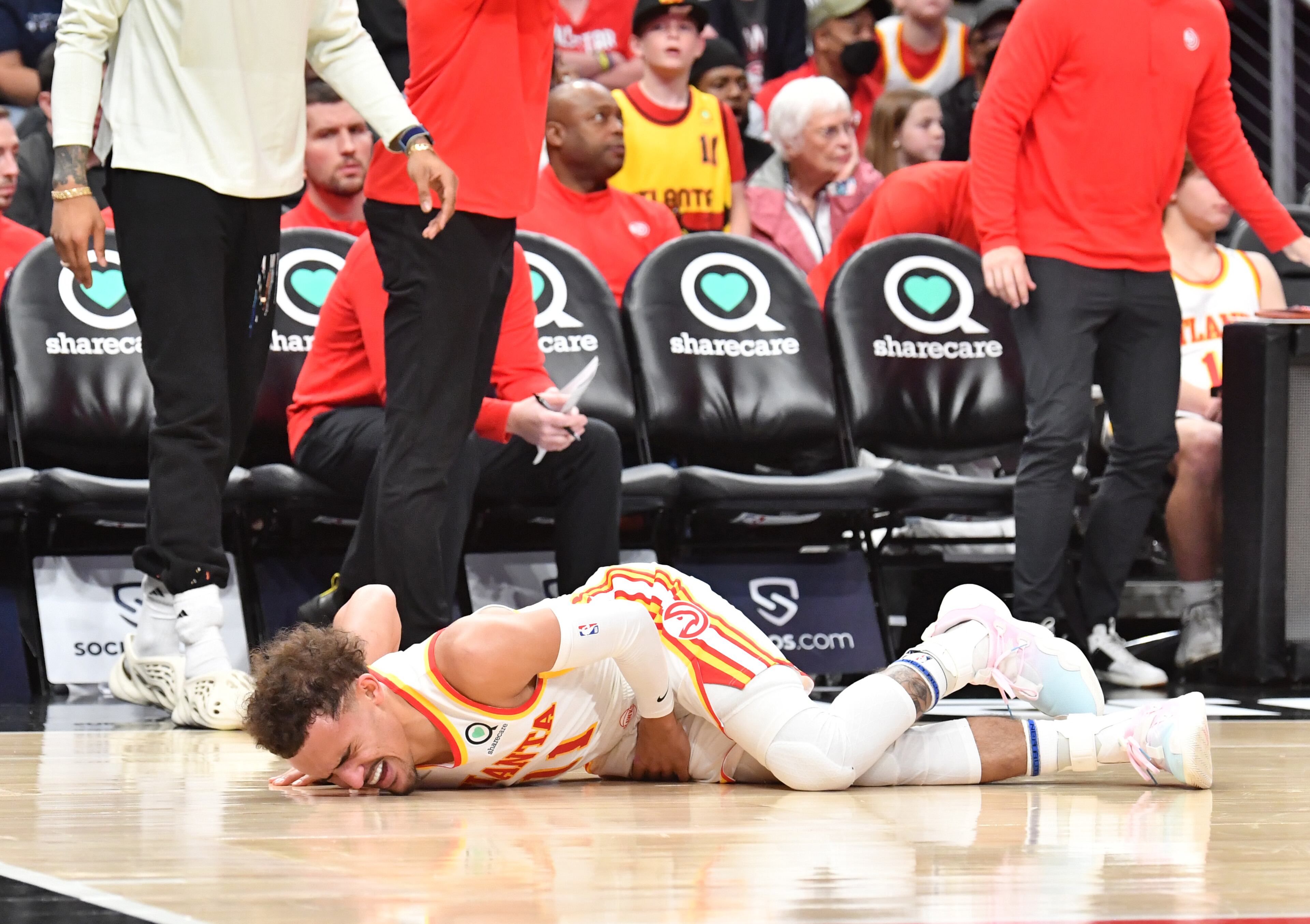 Hawks' guard Trae Young (11) reacts after falling to the court during the first half in an NBA basketball game at State Farm Arena on Thursday, March 31, 2022. Atlanta Hawks won 131-107 over Cleveland Cavaliers. (Hyosub Shin / Hyosub.Shin@ajc.com)