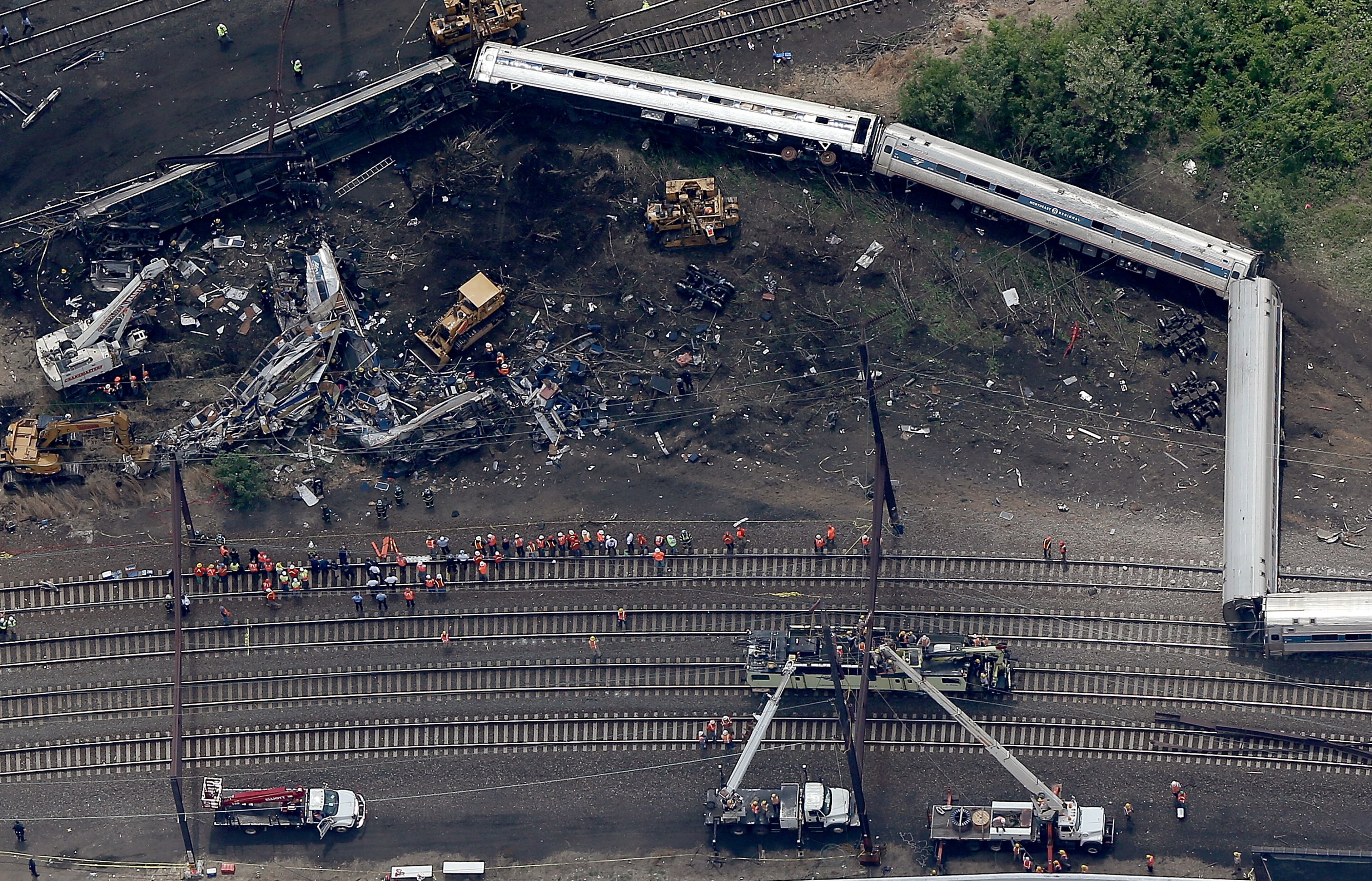 Investigators and first responders work near the wreckage of Amtrak Northeast Regional Train 188, from Washington to New York, that derailed yesterday May 13, 2015 in north Philadelphia, Pennsylvania. At least six people were killed and more than 200 others were injured in the crash. (Photo by Win McNamee/Getty Images)