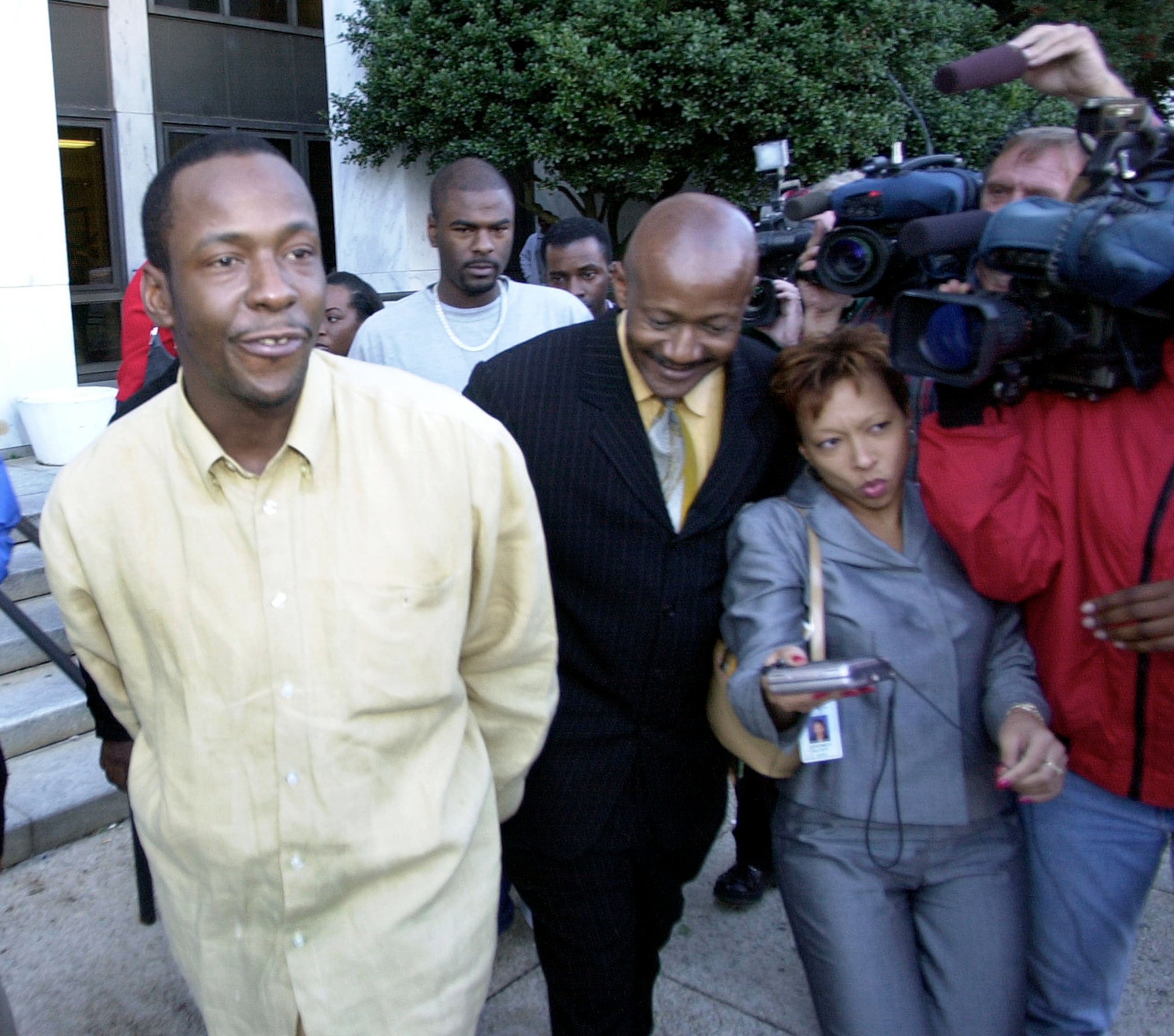Singer Bobby Brown, left, and his attorney Xavier Dicks make their way past reporters as they leave the Dekalb County Courthouse in Decatur, Ga., Friday, Nov. 8, 2002. Brown's appearance in court was for charges dating to 1997 which included failing to appear in court, DUI, speeding, failing to maintain a lane and having no proof of insurance. (AP Photo/John Bazemore)