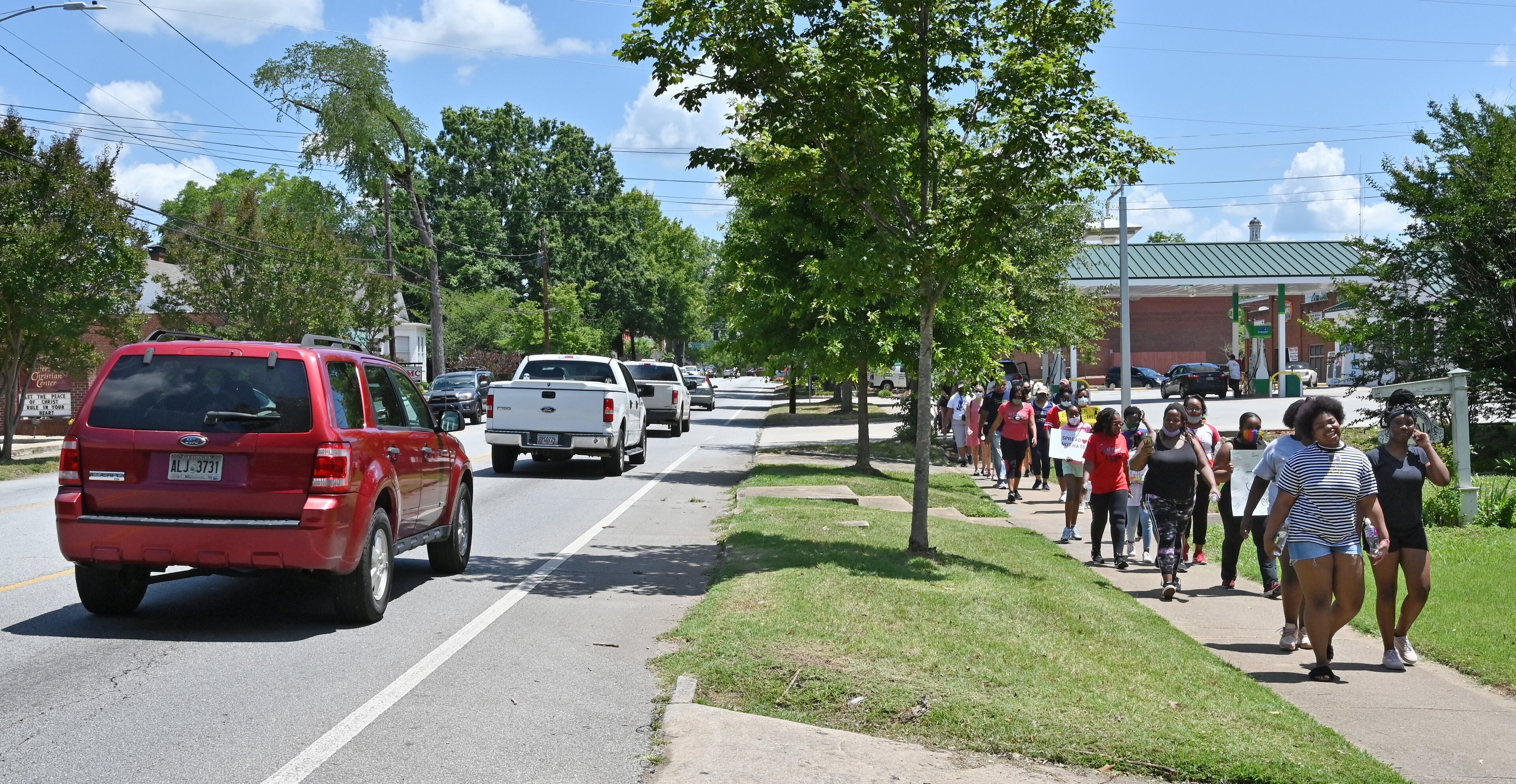 June 19, 2020 Madison - About 200 Morgan County residents demonstrate during a peaceful, youth-led march in downtown Madison on Friday, June 19, 2020. As protests in response to the death of George Floyd spread nationwide earlier this month, they started to pop up in some unexpected places: namely, the Atlanta exurbs, places like Cartersville, Peachtree City, Forsyth County, Braselton and Madison -- the predominantly white town about an hour east on I-20, whose main street is still lined with antebellum homes that Gen. Sherman purportedly found too beautiful to burn. (Hyosub Shin / Hyosub.Shin@ajc.com)