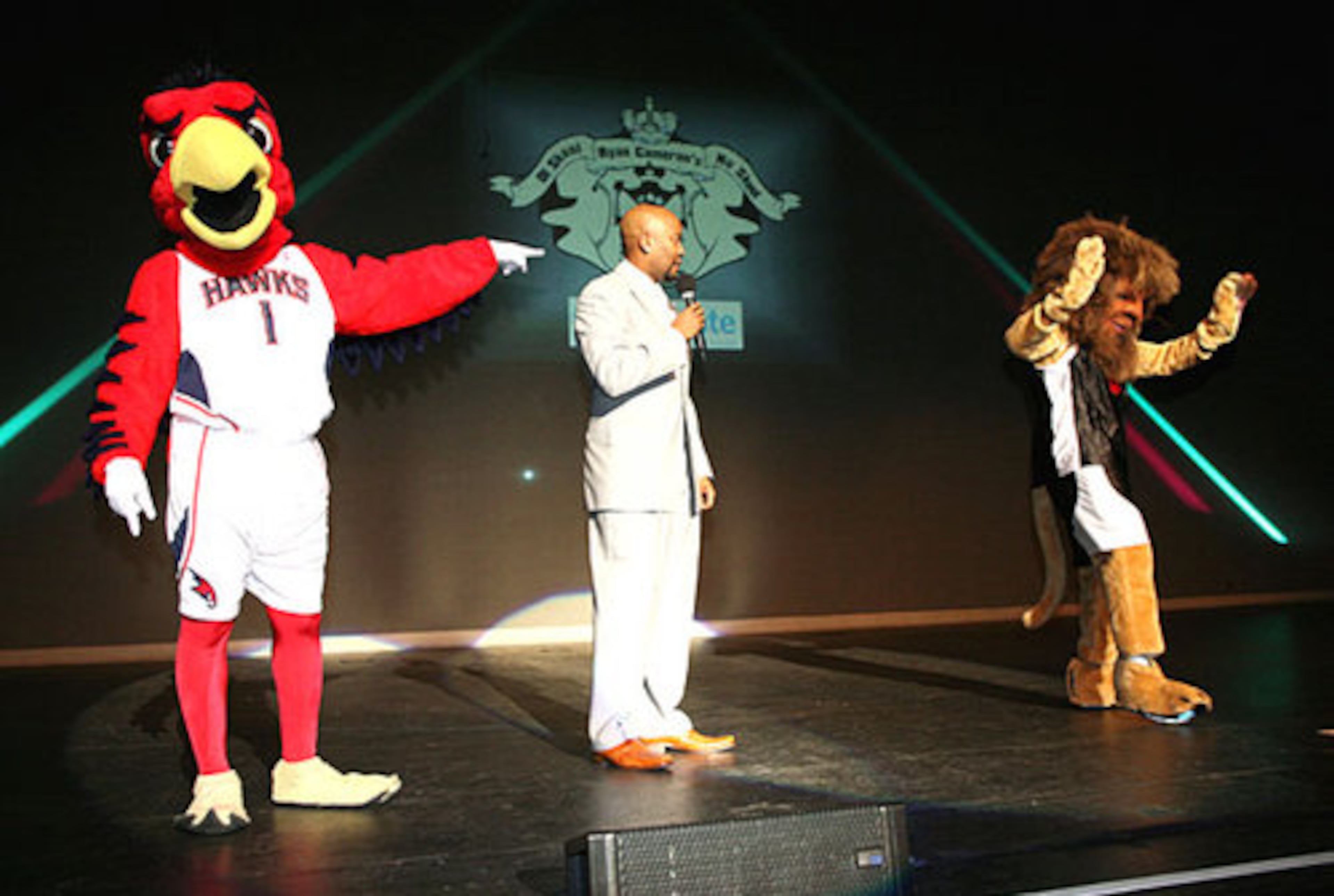 Harry the Hawk and Ryan Lion join Atlanta radio host Ryan Cameron onstage.