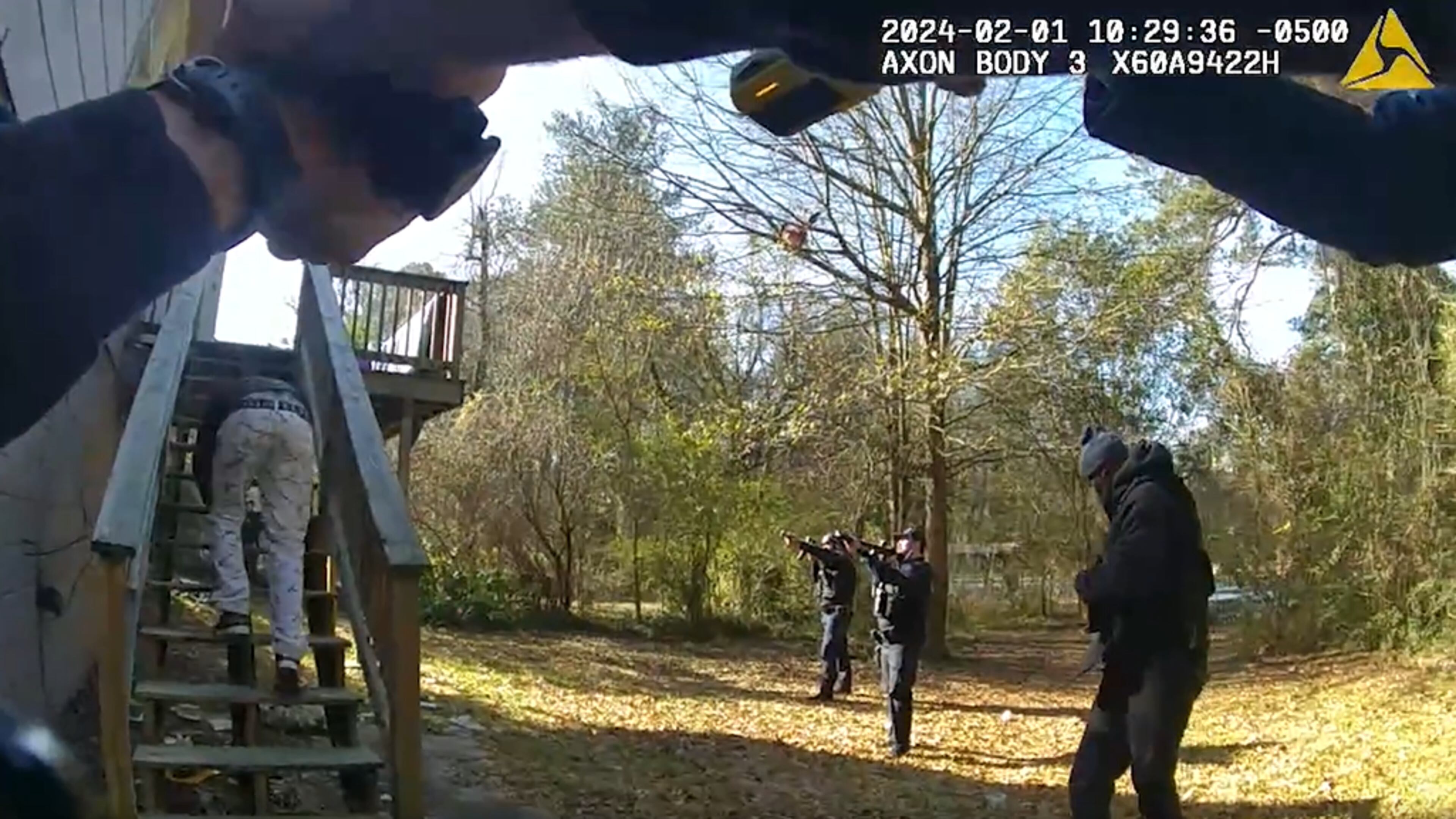 Murder suspect Landon Gibson crawls down the back steps of a home where he was located by homicide investigators, according to Atlanta police.