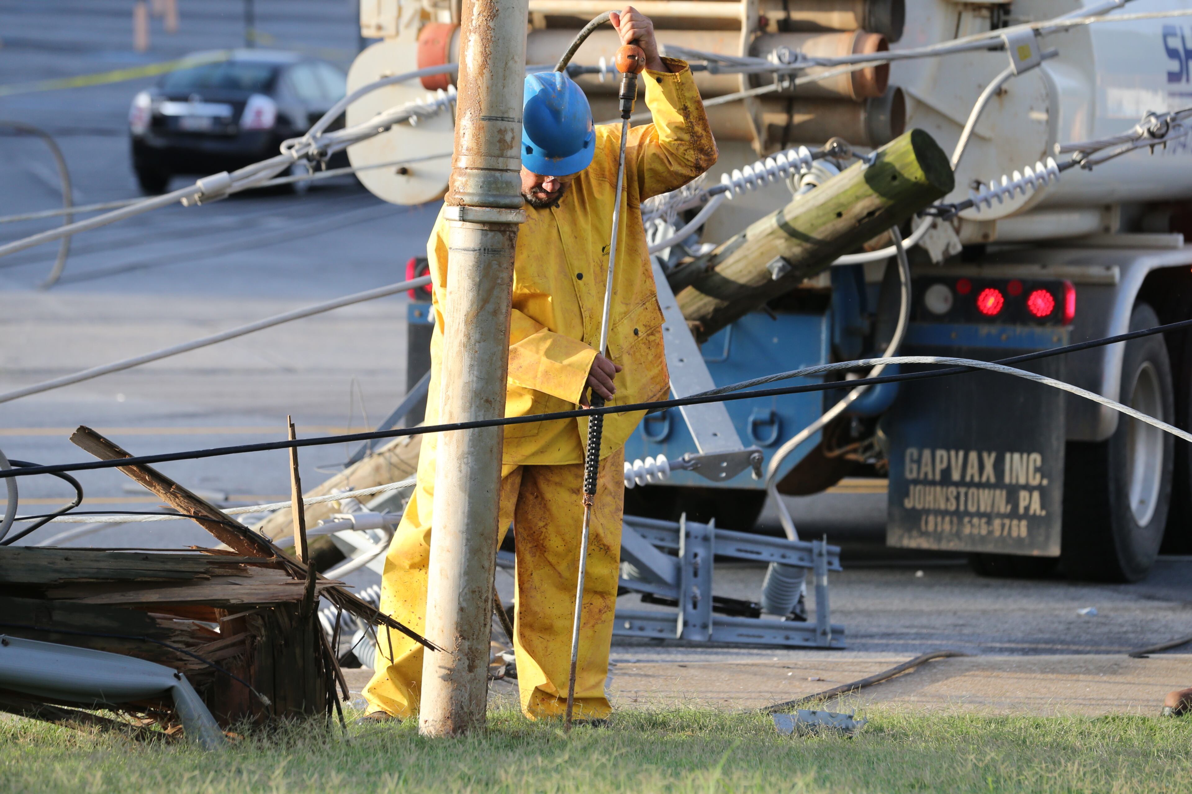 A second pole also fell onto a nearby grassy area. It was not immediately clear what caused the poles to topple. JOHN SPINK/JSPINK@AJC.COM