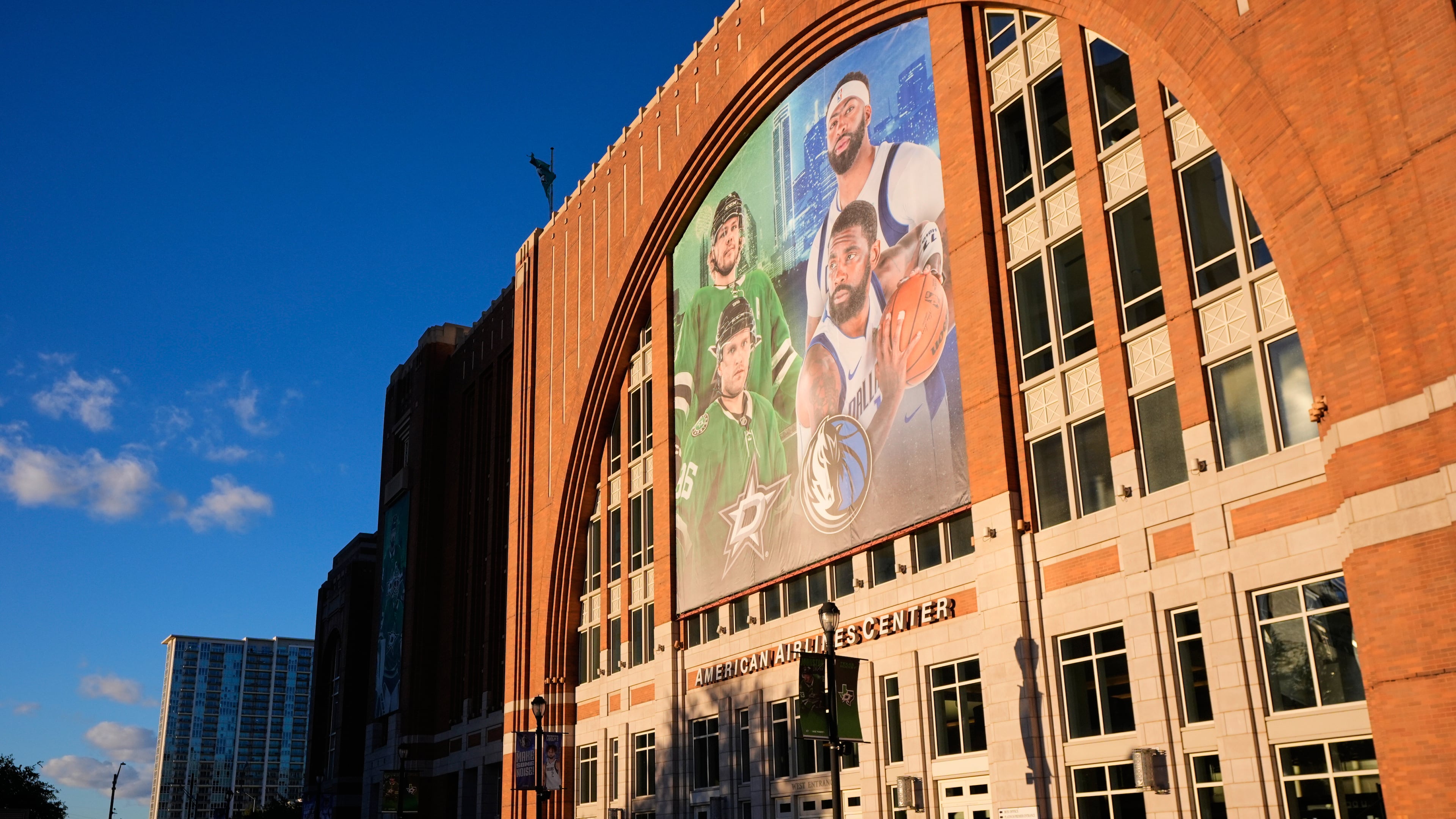 FILE - Fans line up outside the doors of American Airlines Center before the start of an NHL hockey game in Dallas, on Tuesday, Oct. 28, 2025. (AP Photo/Tony Gutierrez, File)