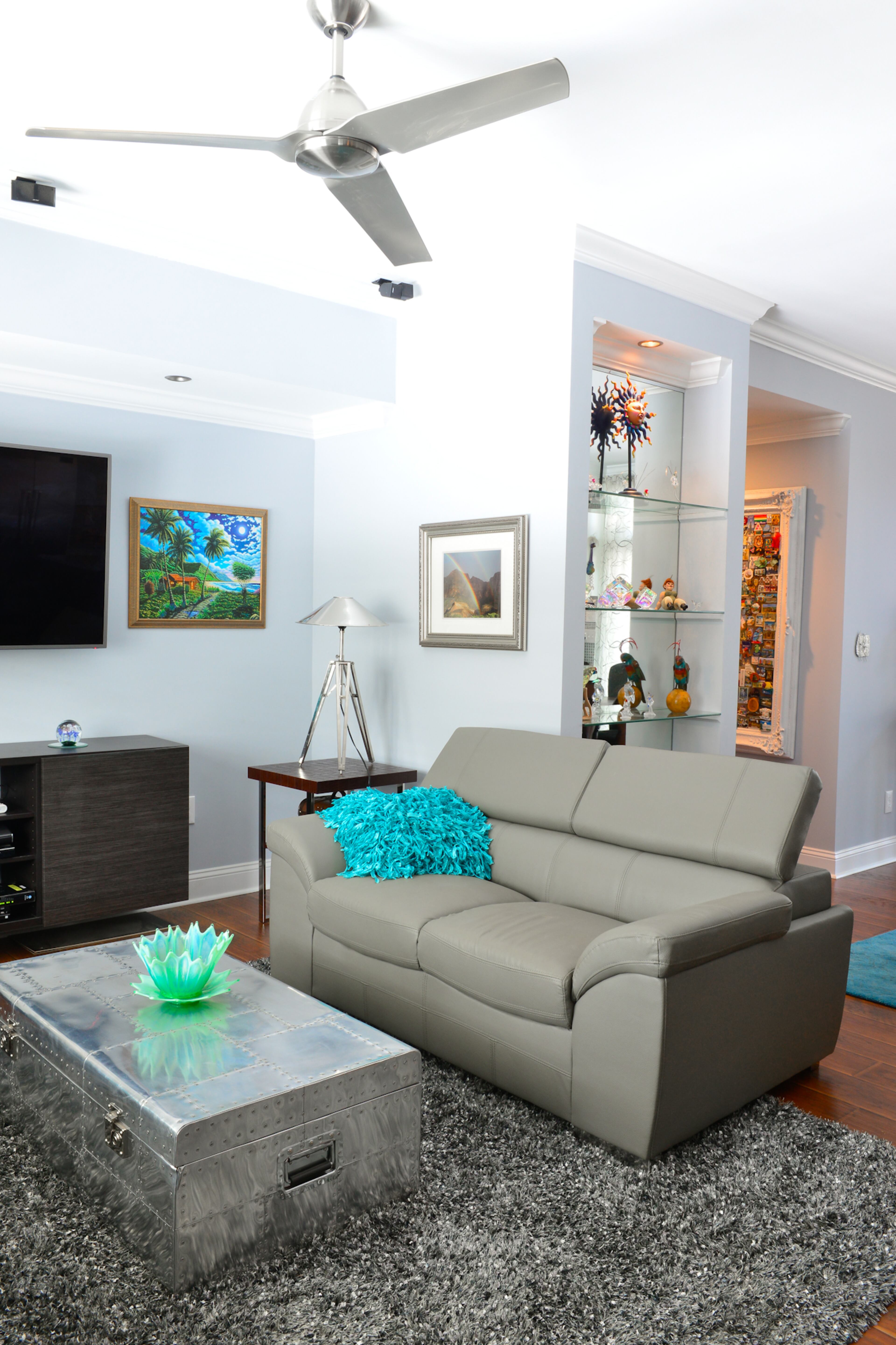 Homeowners Michael Bush and Johnny Mitchell tore down walls to open up the home during renovations to the ranch-style house, which was built in 1952. A stainless steel coffee table and side table provide contemporary flair to the living room, which also has a modern ceiling fan and Benjamin Moore's Metallic Silver paint.