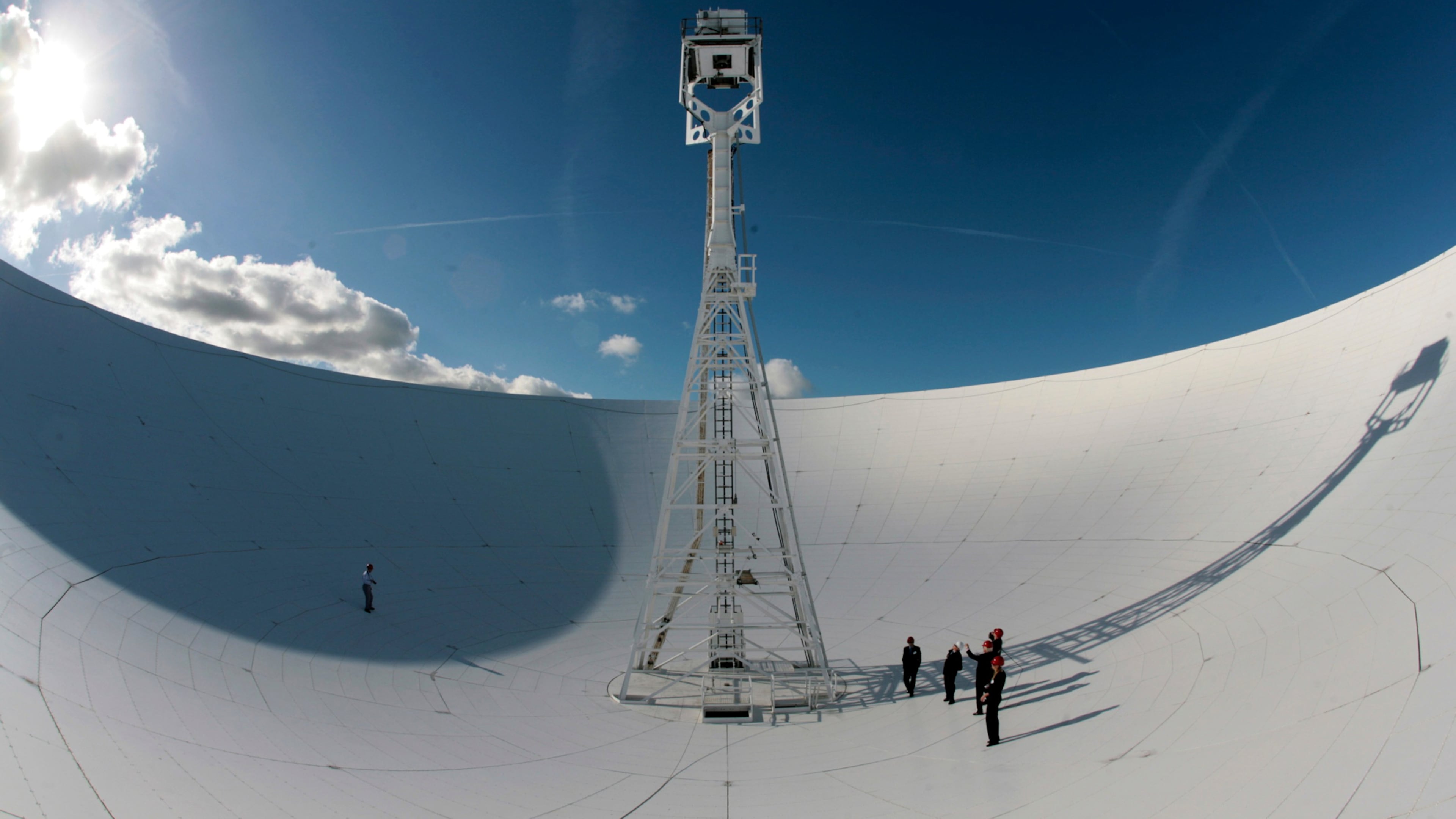 FILE - Members of a conference to mark the 50th anniversary of space travel stand in the dish of the The Lovell Telescope at Jodrell Bank Observatory, Macclesfield, England Thursday Oct. 4, 2007. (AP Photo/Jon Super, file)