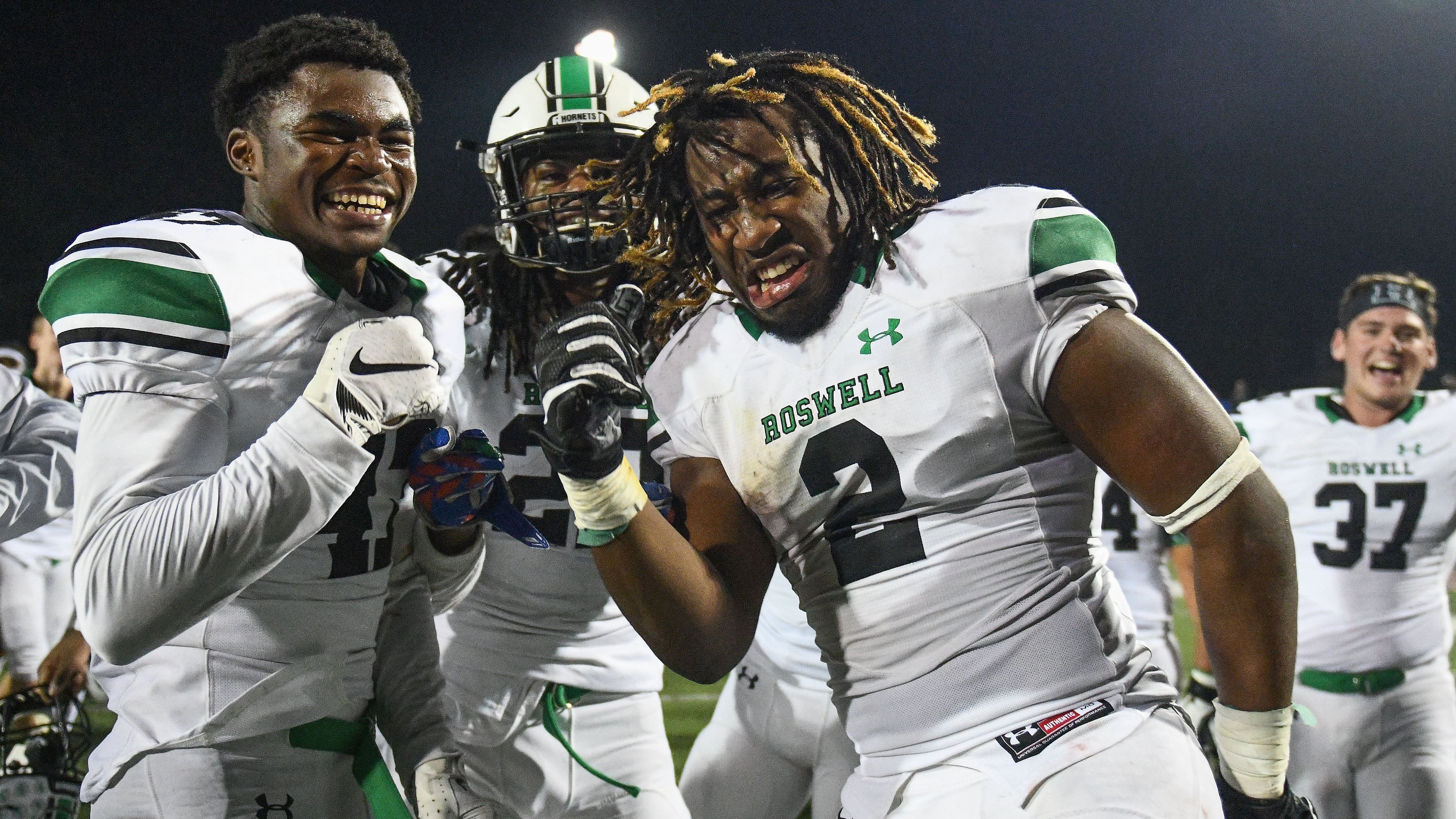 Friday Night football: Roswell's Doneiko Slaughter (47), Tyron Hopper (22) and Kamonty Jett (2) celebrate after Friday's 32-31 victory over Walton. (AJ Reynolds/Special)