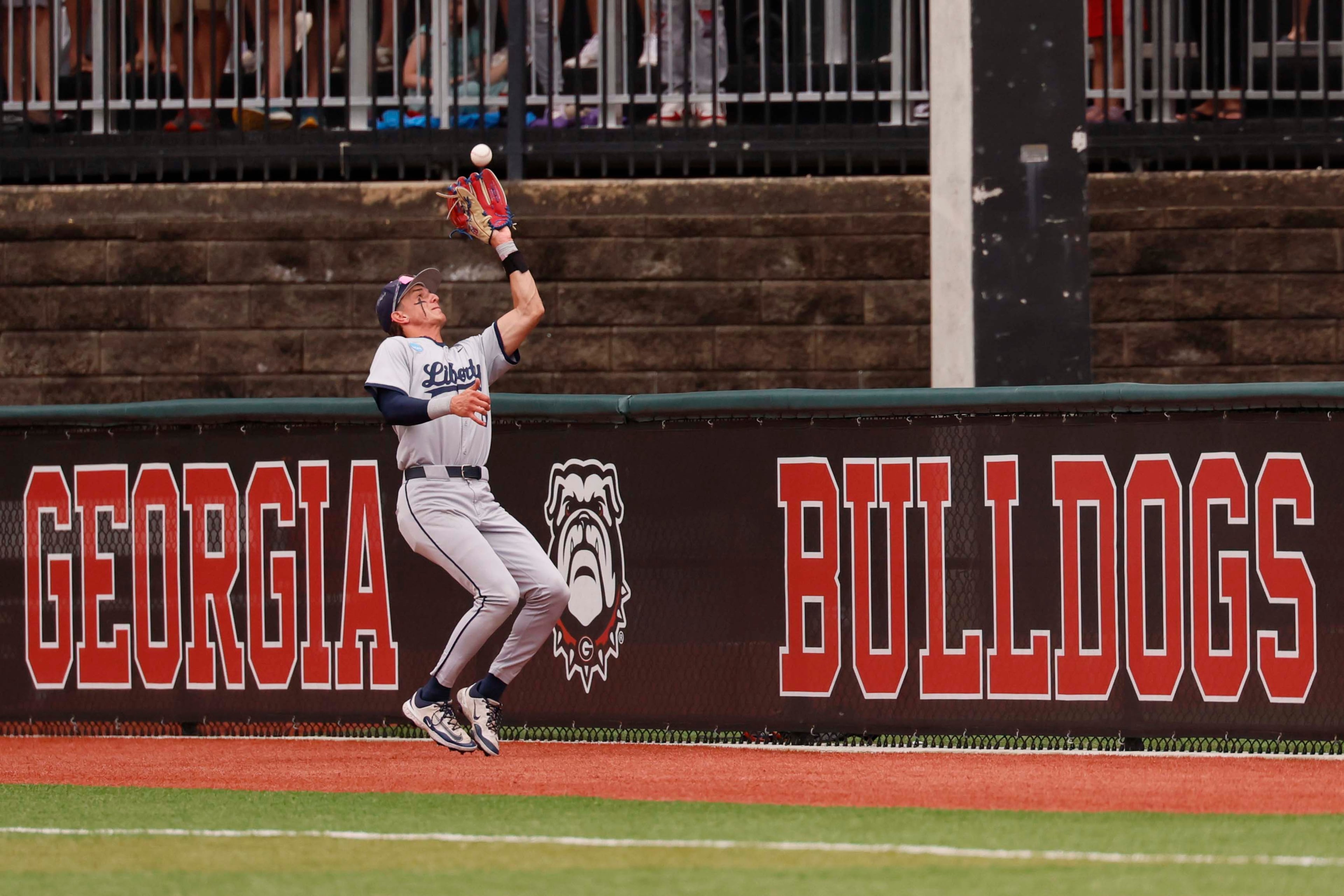 Liberty Flames infielder Landon Scilley (6) catches a fly ball during the fourth inning of their NCAA Regional final game at Foley Field on Sunday, May 31, 2026, in Athens. (Miguel Martinez/AJC)