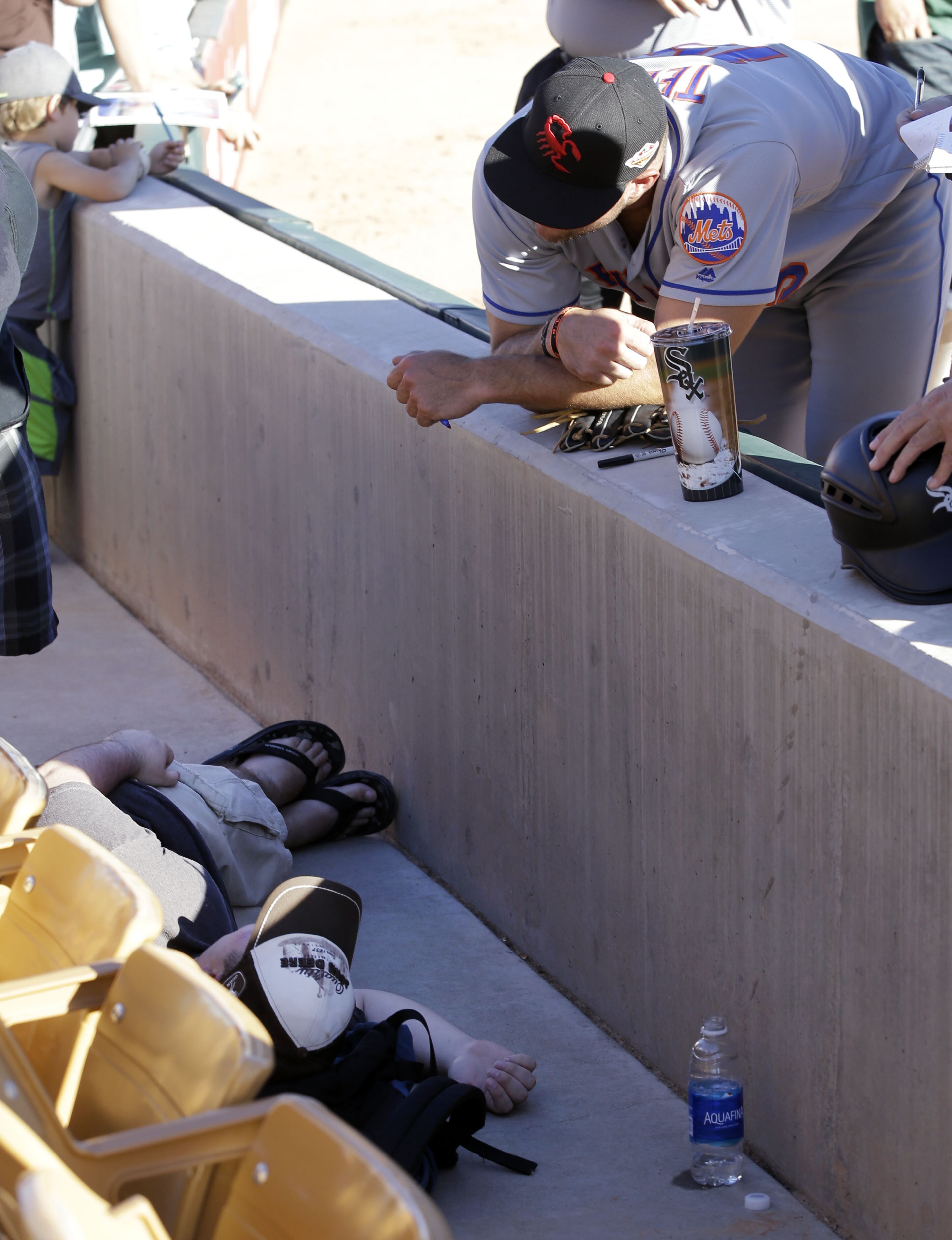 Scottsdale Scorpions outfielder Tim Tebow stands near a fan who, the Phoenix Fire Department said, was having a seizure, following Tebow's debut against the Glendale Desert Dogs on Tuesday, Oct. 11, 2016, in an Arizona Fall League game in Glendale, Ariz. The fire department said the man was transported to an emergency room. No more details were provided on his condition. (Rob Schumacher/The Arizona Republic via AP)