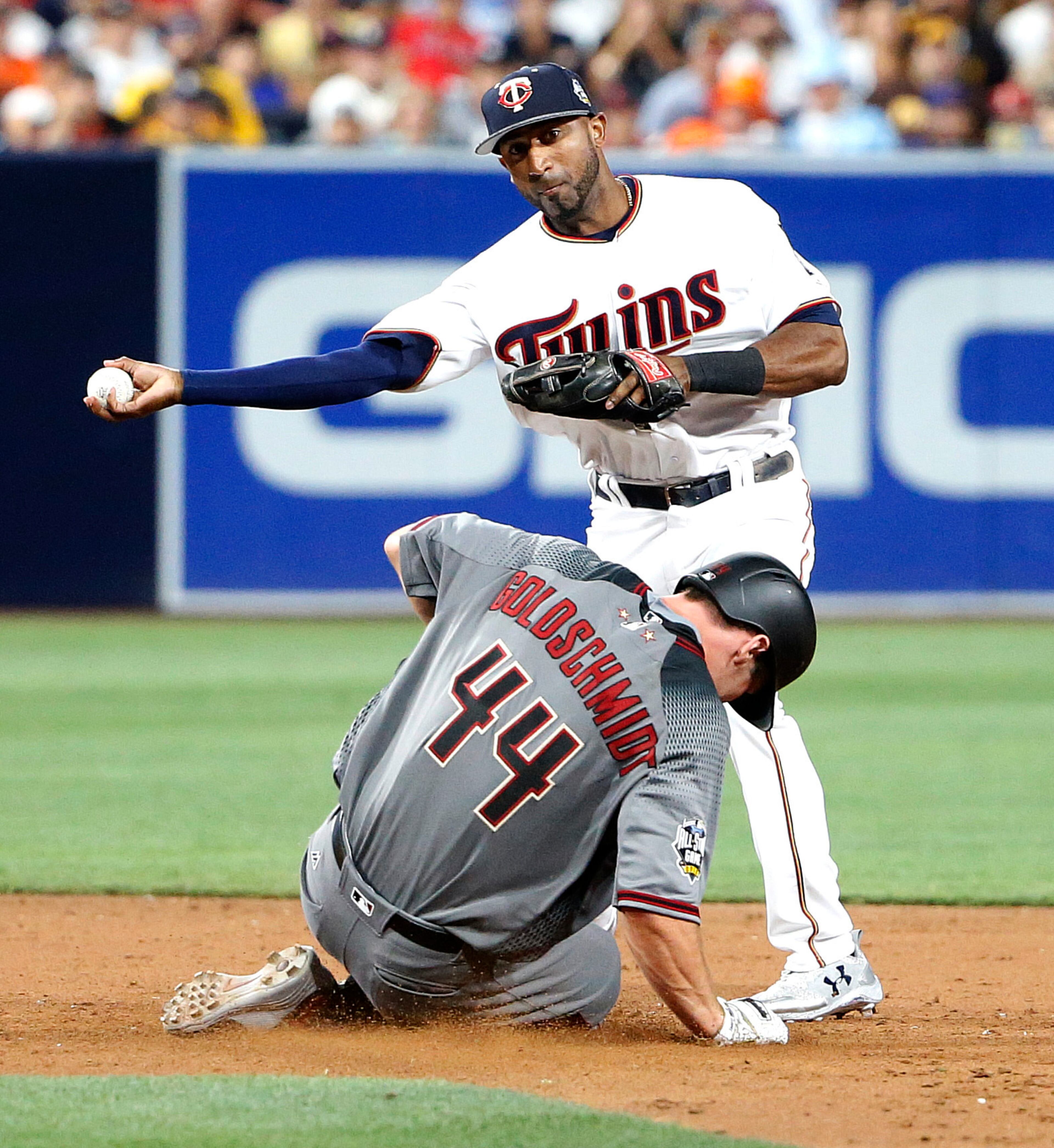 American League's Eduardo Nunez, of the Minnesota Twins, forces out National League's Paul Goldschmidt, of the Arizona Diamondbacks, as he turns a game-ending double play on National League's Nolan Arenado, of the Colorado Rockies, to end the MLB baseball All-Star Game, Tuesday, July 12, 2016, in San Diego. The American League won 4-2. (AP Photo/Lenny Ignelzi)