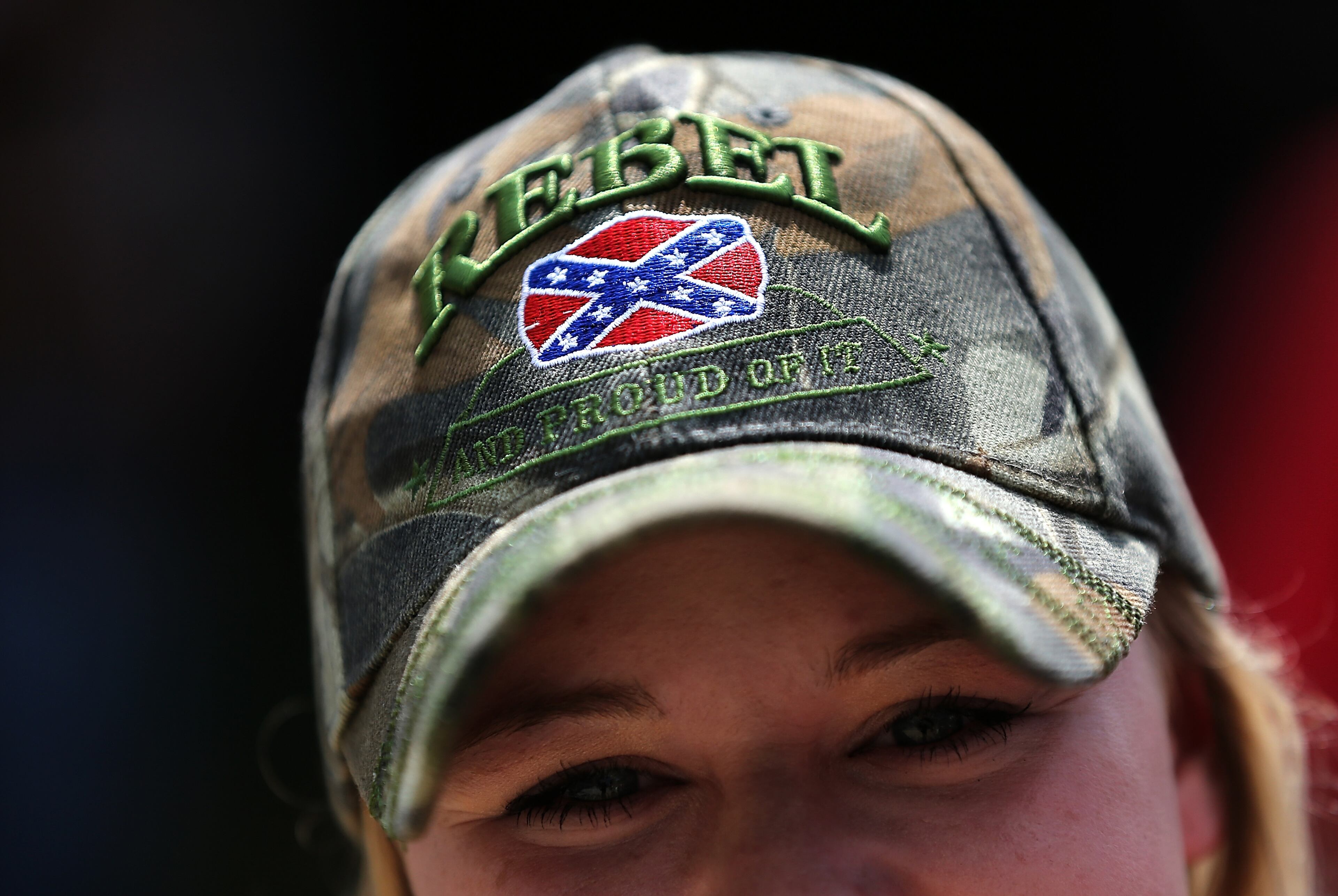 COLUMBIA, SC - JUNE 27: Katie Crum, of Columbia, South Carolina joins a group of demonstrators on the grounds of the South Carolina State House calling for the Confederate flag to remain on the State House grounds June 27, 2015 in Columbia, South Carolina. Earlier in the week South Carolina Gov. Nikki Haley expressed support for removing the Confederate flag from the State House grounds in the wake of the nine murders at Mother Emanuel A.M.E. Church in Charleston, South Carolina. (Photo by Win McNamee/Getty Images)