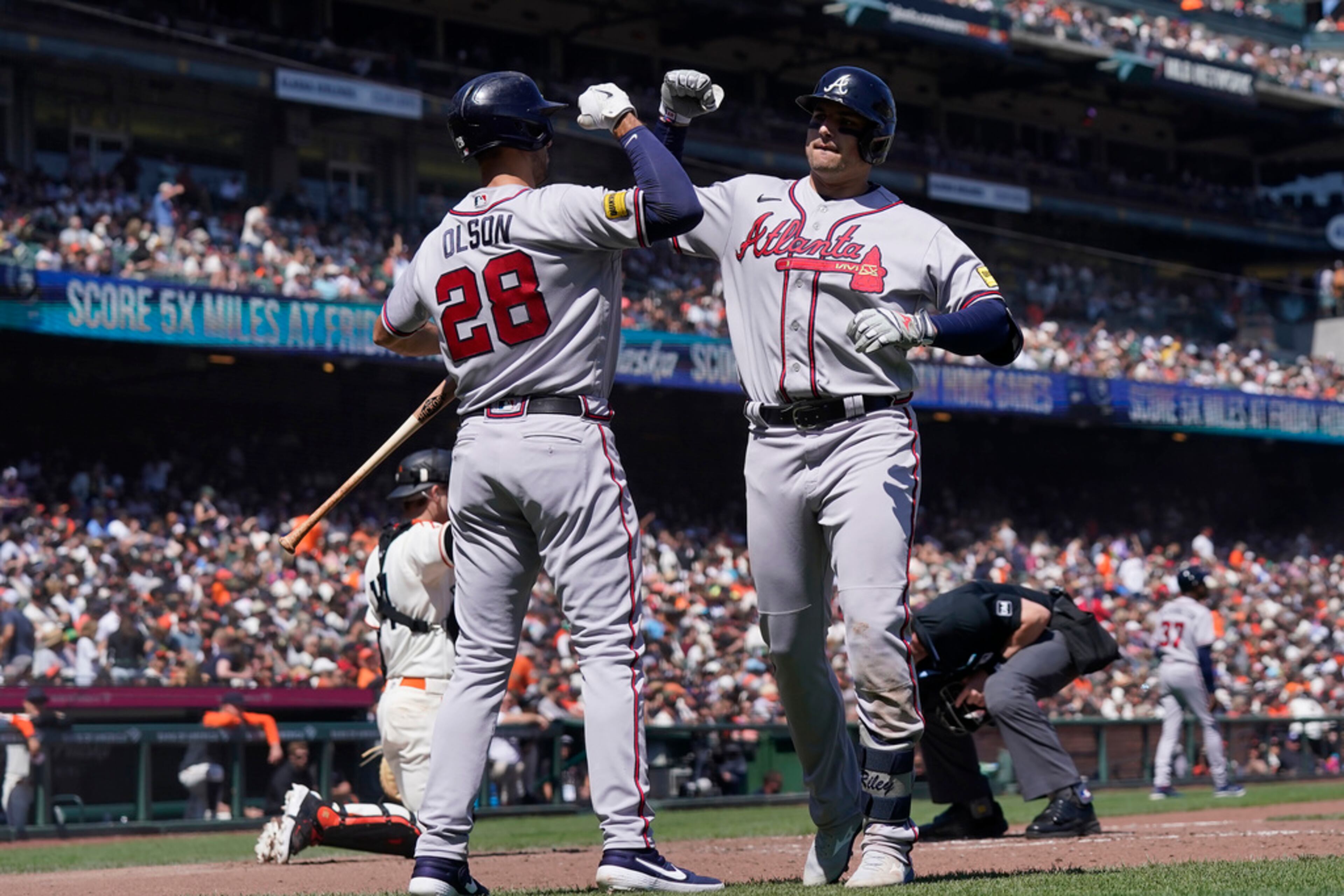 Atlanta Braves' Austin Riley, front right, is congratulated by Matt Olson (28) after hitting a home run against the San Francisco Giants during the fifth inning of a baseball game in San Francisco, Saturday, Aug. 26, 2023. (AP Photo/Jeff Chiu)