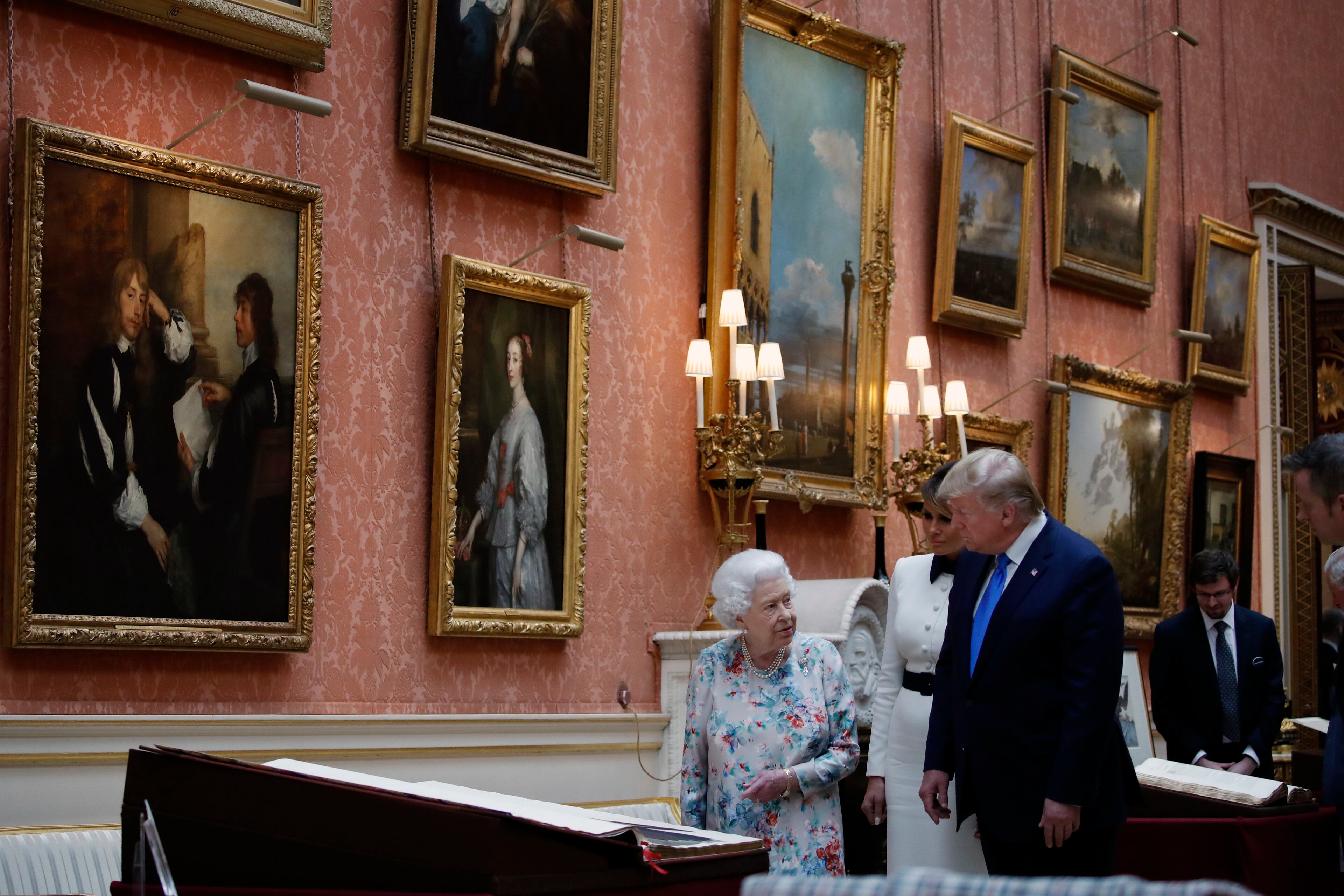 President Donald Trump, first lady Melania Trump and Queen Elizabeth II, walk in the Picture Gallery at Buckingham Palace, Monday, June 3, 2019, in London. (AP Photo/Alex Brandon)