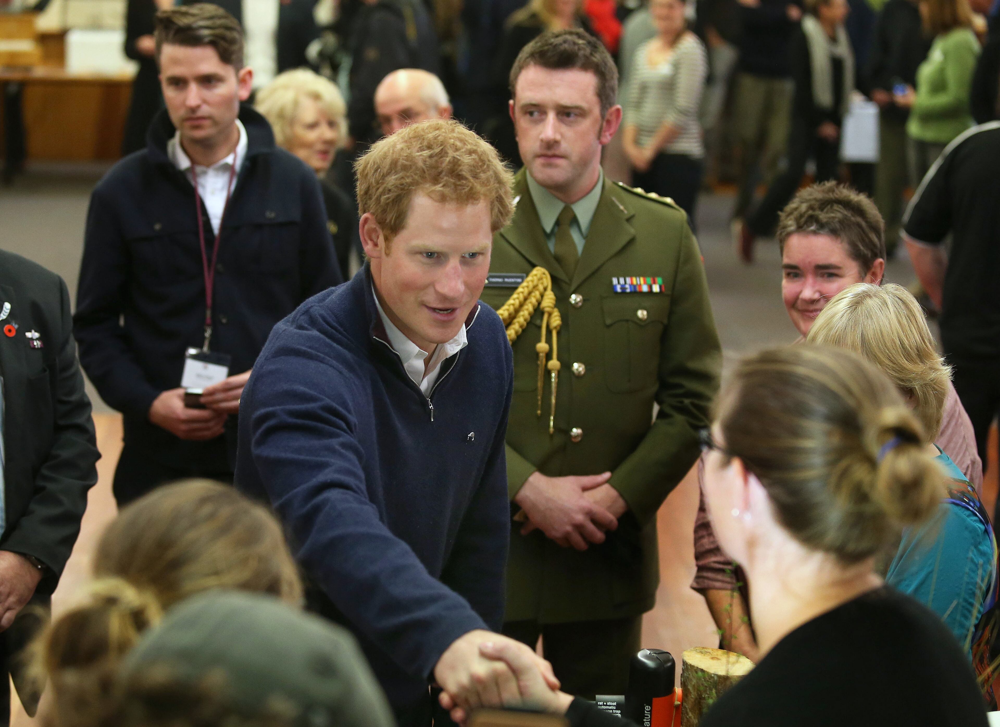 Britain's Prince Harry, center, visits the Stewart Island Community Centre as part of his first visit to New Zealand, on May 10, 2015.