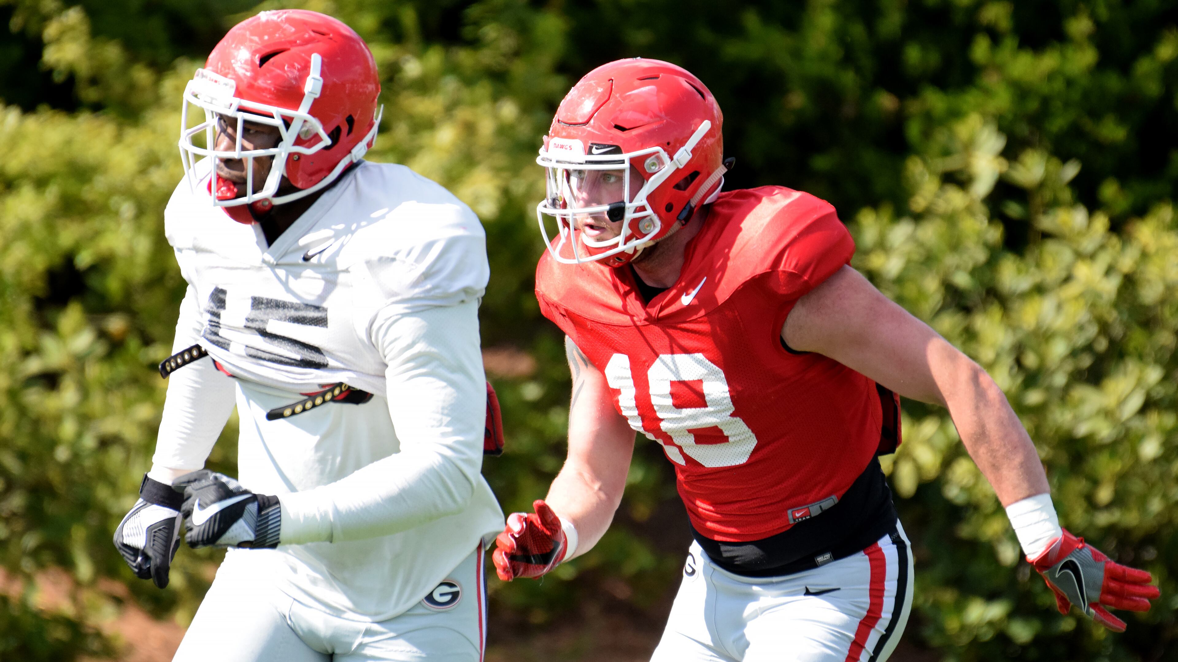 Georgia outside linebacker D'Andre Walker (15) and Georgia tight end Isaac Nauta (18) during the Bulldogs' practice Tuesday, April 10, 2018, on the Woodruff Practice Fields in Athens.