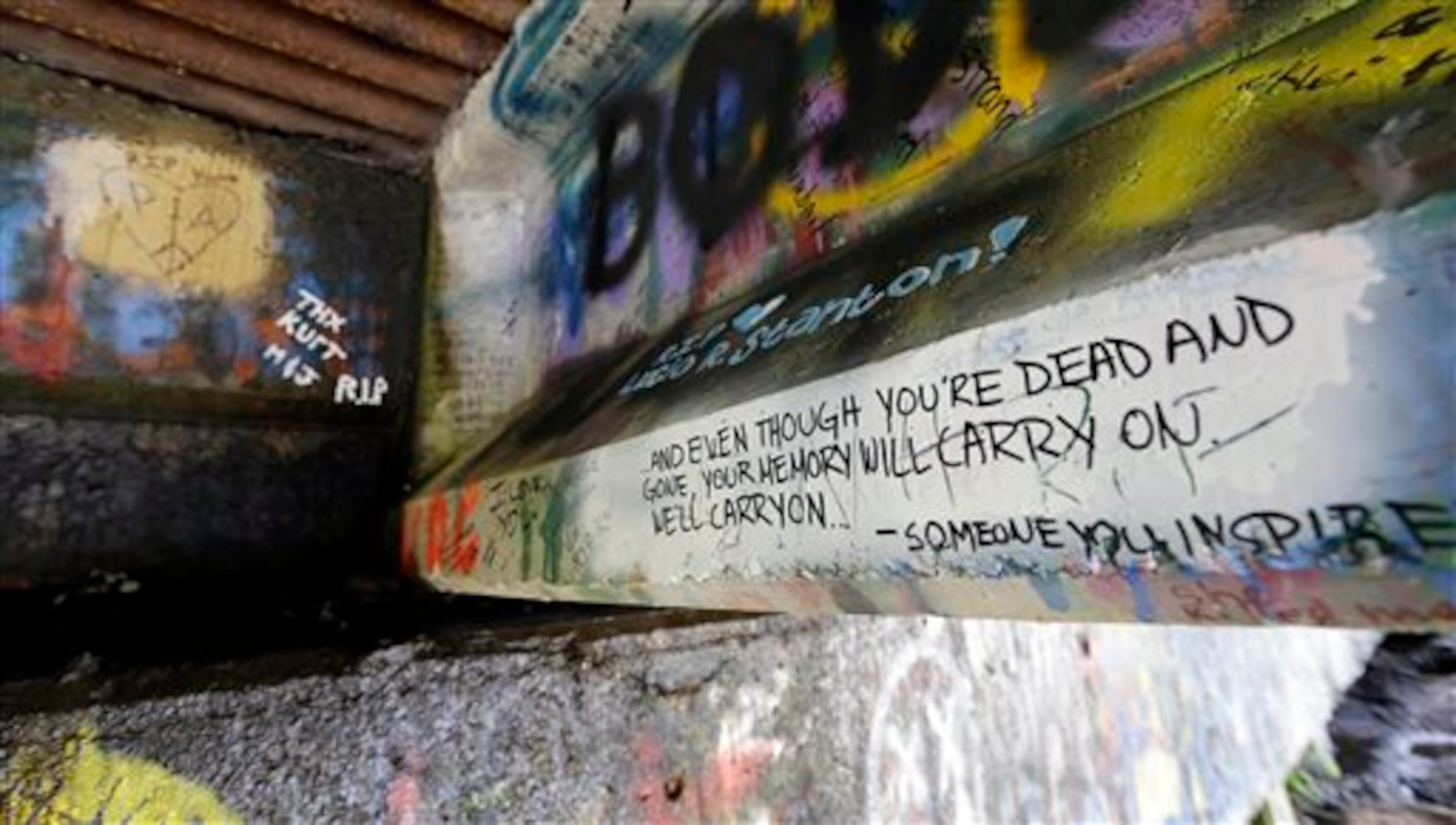 In this photo taken Monday, Sept. 23, 2013, graffiti, mostly written about Kurt Cobain, the late frontman of Nirvana, adorns the underside of the Young Street Bridge blocks from his childhood home in Aberdeen, Wash. Cobain's mother is putting the family's tired, 1.5-story Aberdeen bungalow, where Cobain spent many of his childhood years, on the market this week, the same month as the 20th anniversary of Nirvana's final studio album. The home, last assessed at less than $67,000, is being listed for $500,000, but the family would also be happy entering into a partnership with anyone who wants to turn it into a museum. (AP Photo/Elaine Thompson)