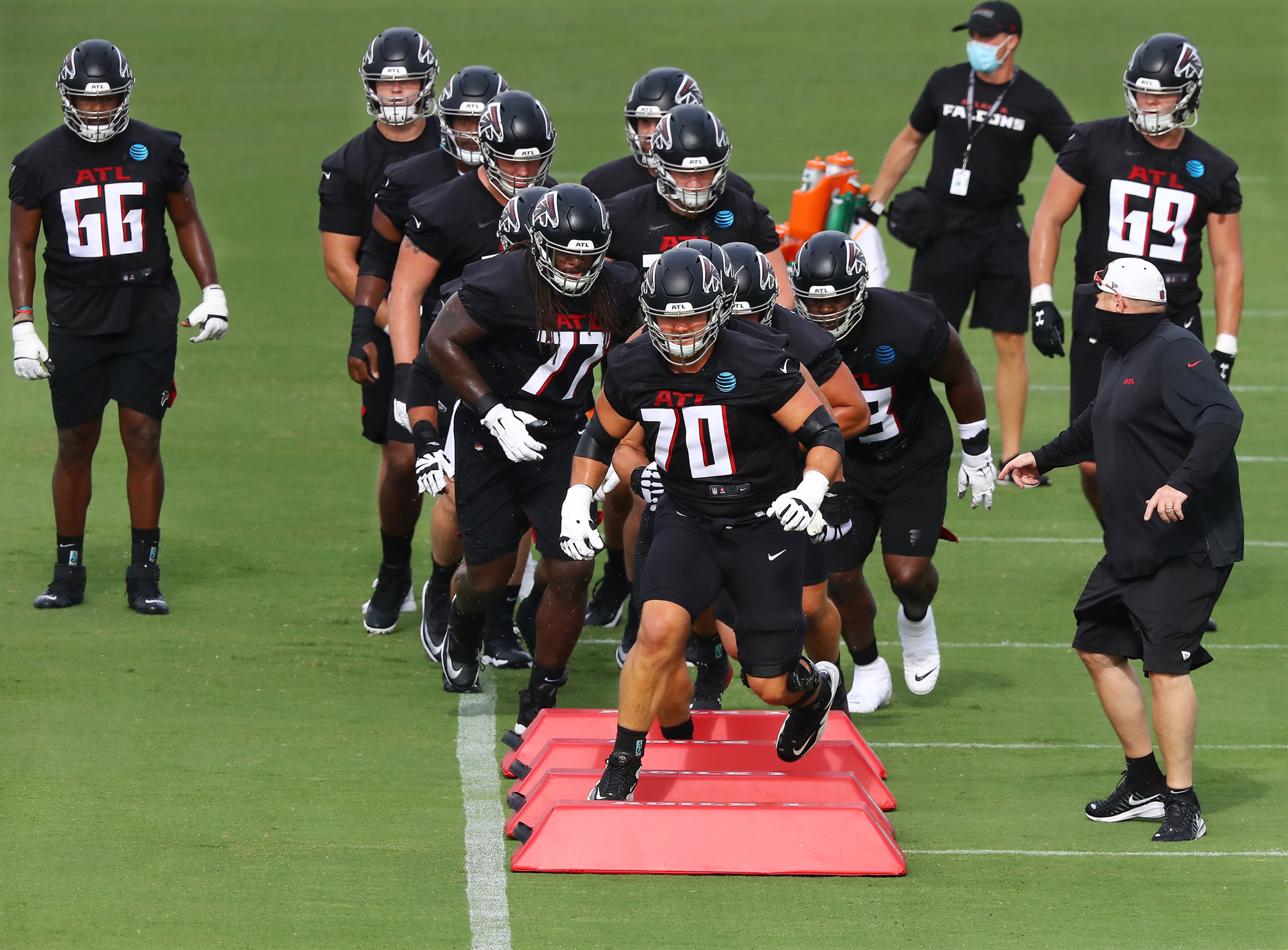 Falcons tackle Jake Matthews leads offensive lineman through an agility drill during training camp on Saturday, August 15, 2020 in Flowery Branch. Curtis Compton ccompton@ajc.com