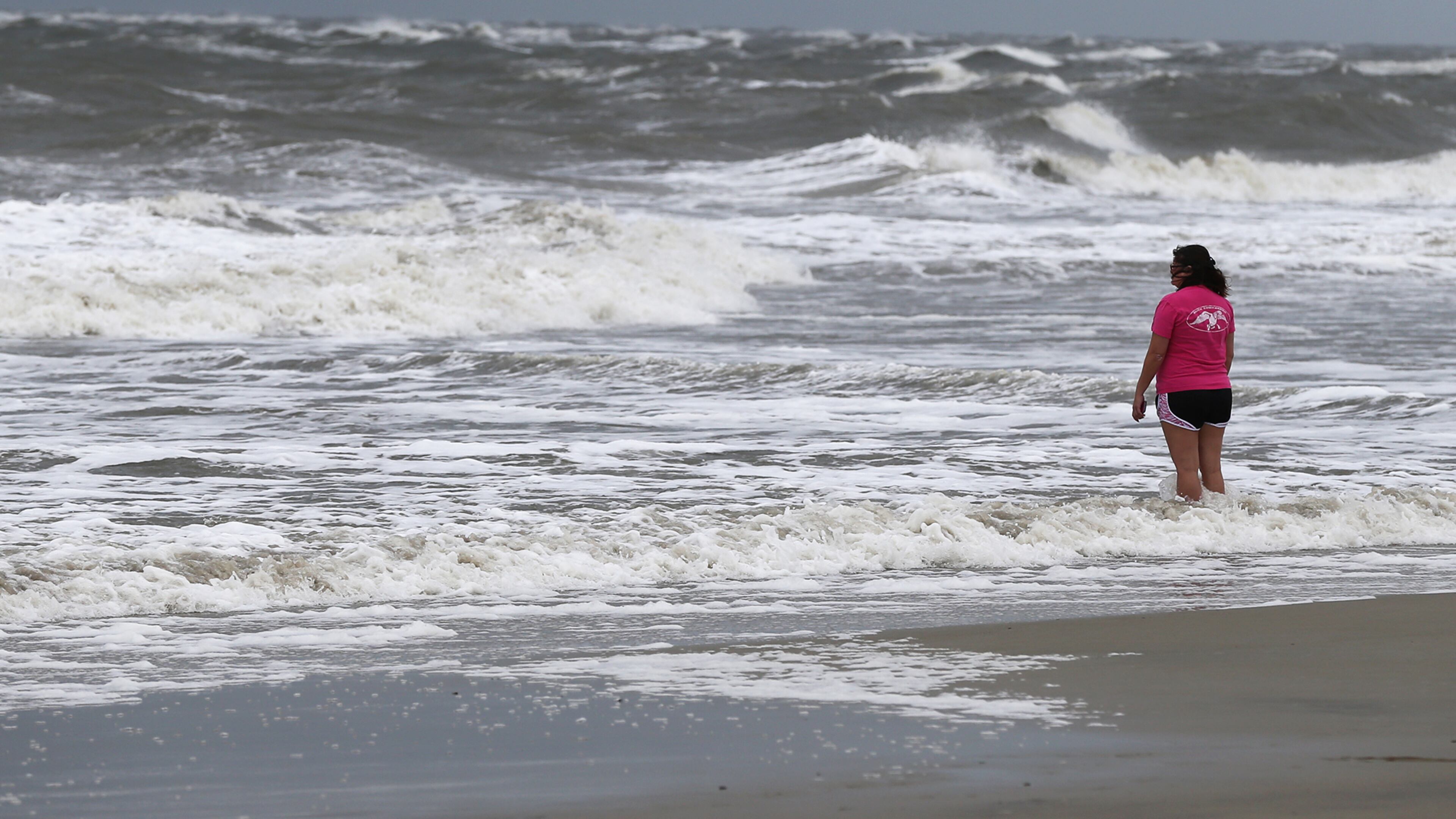 A woman takes in the surf in September before Hurricane Irma arrives at Tybee Island. The beaches on Tybee, Jekyll and St. Simons islands suffered heavy damage when Hurricanes Irma and Matthew battered them. Curtis Compton/ccompton@ajc.com