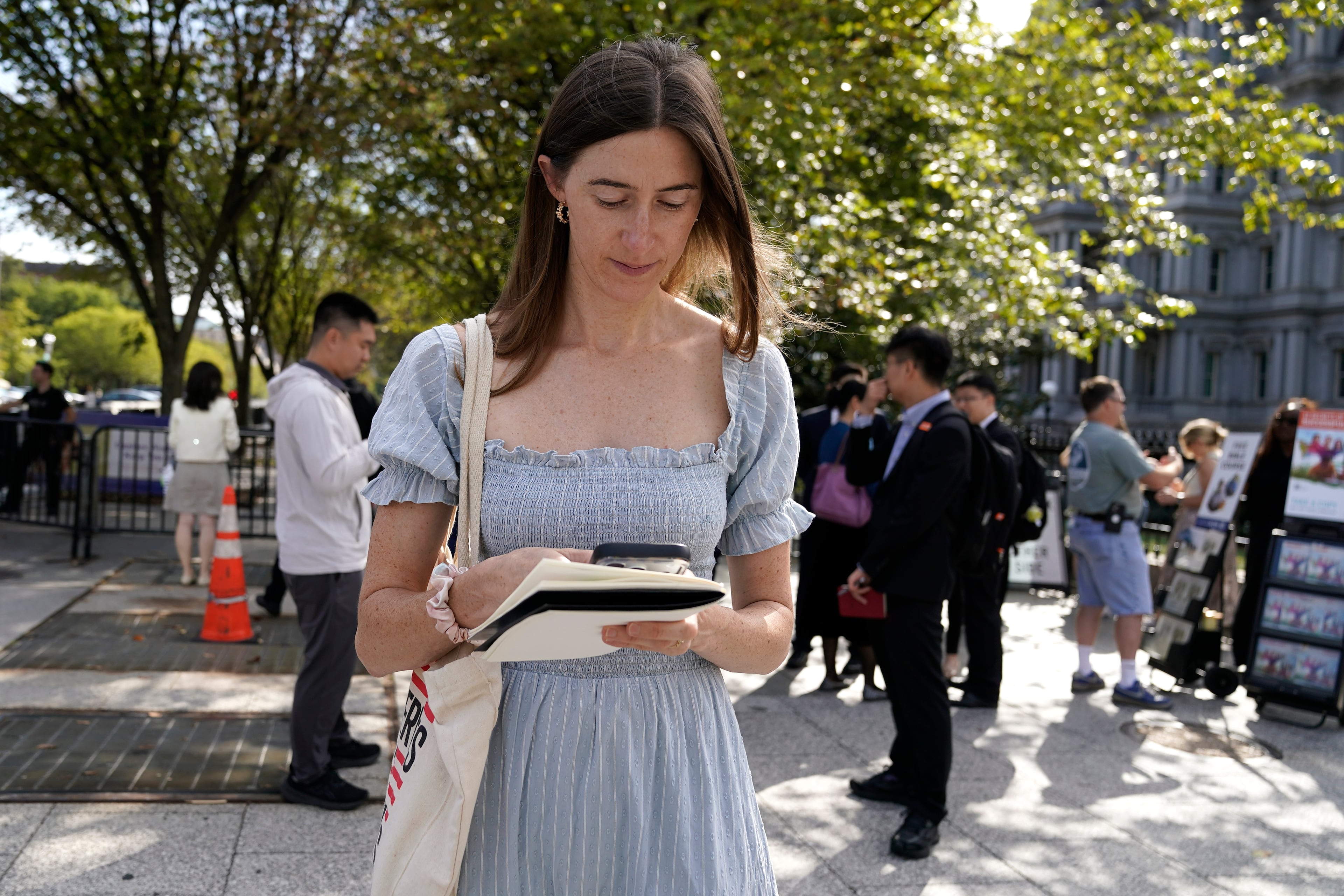 Politico White House reporter Cheyenne Haslett is pictured near the White House complex after having her credential revoked following President Donald Trump's ban on CNN, MS NOW and Politico, Saturday, Sept. 19, 2026, in Washington. (Jose Luis Magana/AP)