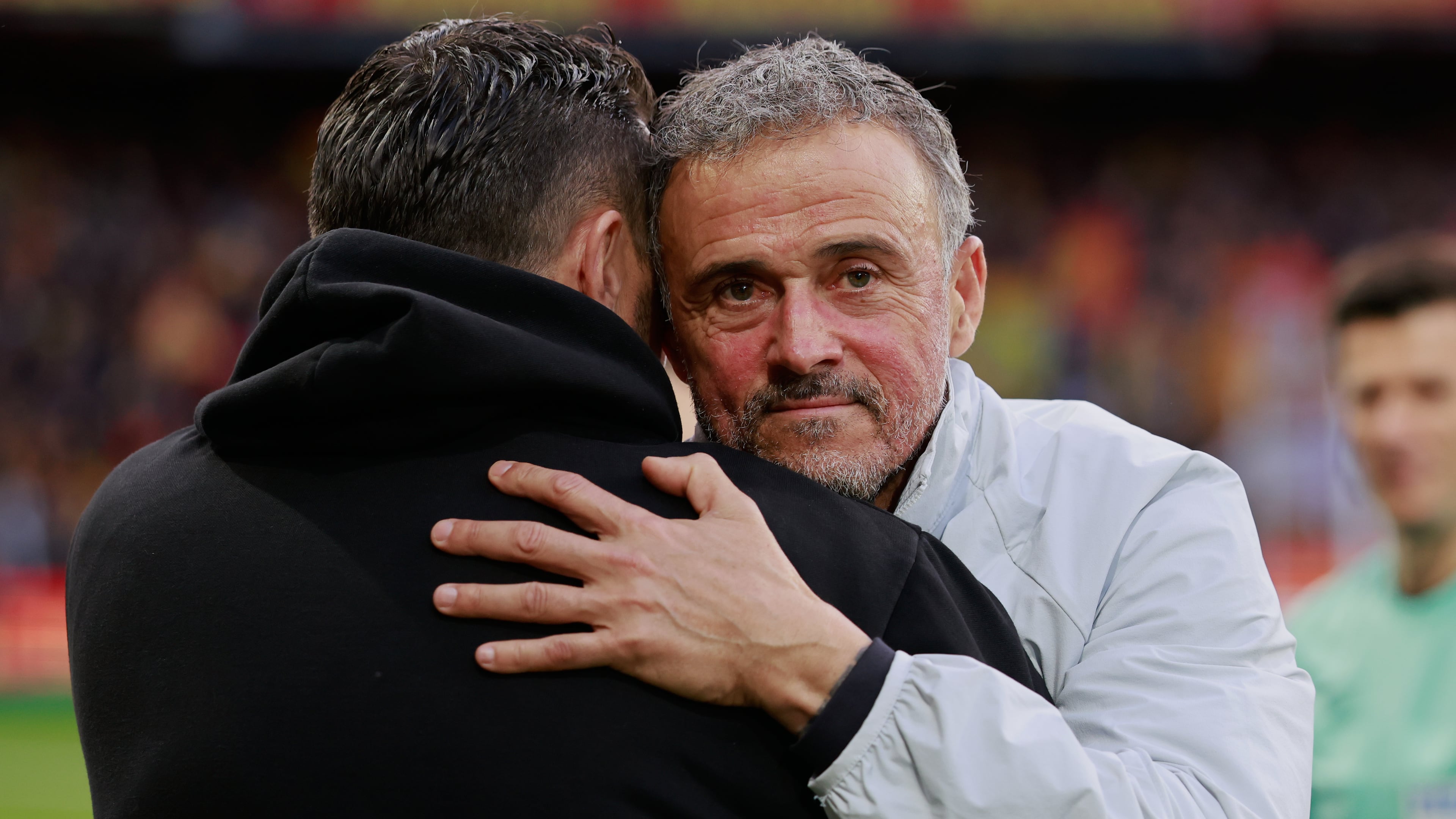 PSG's head coach Luis Enrique, right, hugs Lens' head coach Pierre Sage prior to the start of the French League One soccer match between Lens and Paris Saint Germain, in Lens, northern France, Wednesday, May 13, 2026. (AP Photo/Jean-Francois Badias)