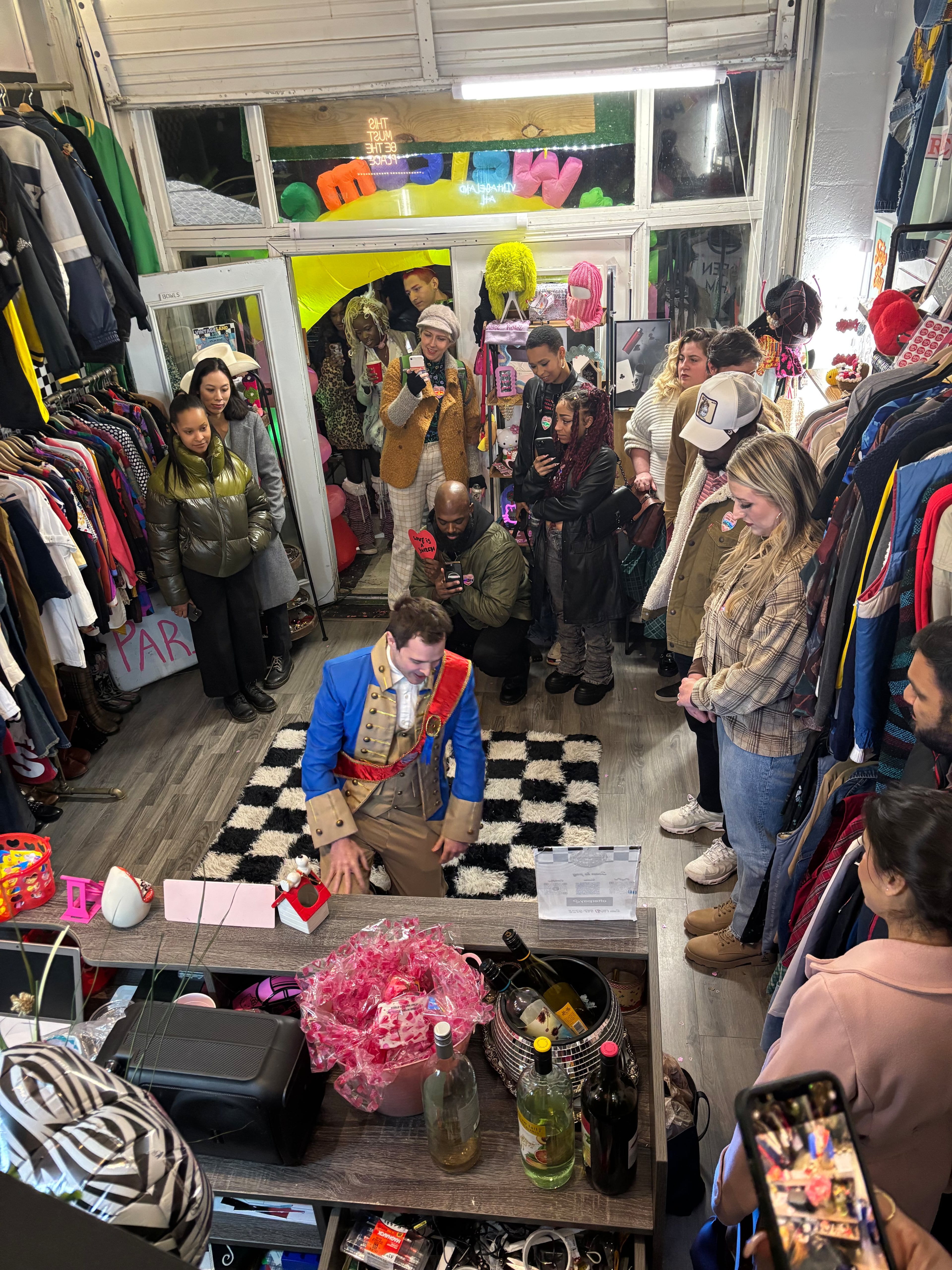 Attendees of the 2024 "Looking for Love in L5P" theatrical experience watch an actor inside a retail store in Little Five Points. The roving show by Media Res Immersive Theatre company is back again this year, this time for two, possibly three, shows. (Courtesy of Louis Kyper)