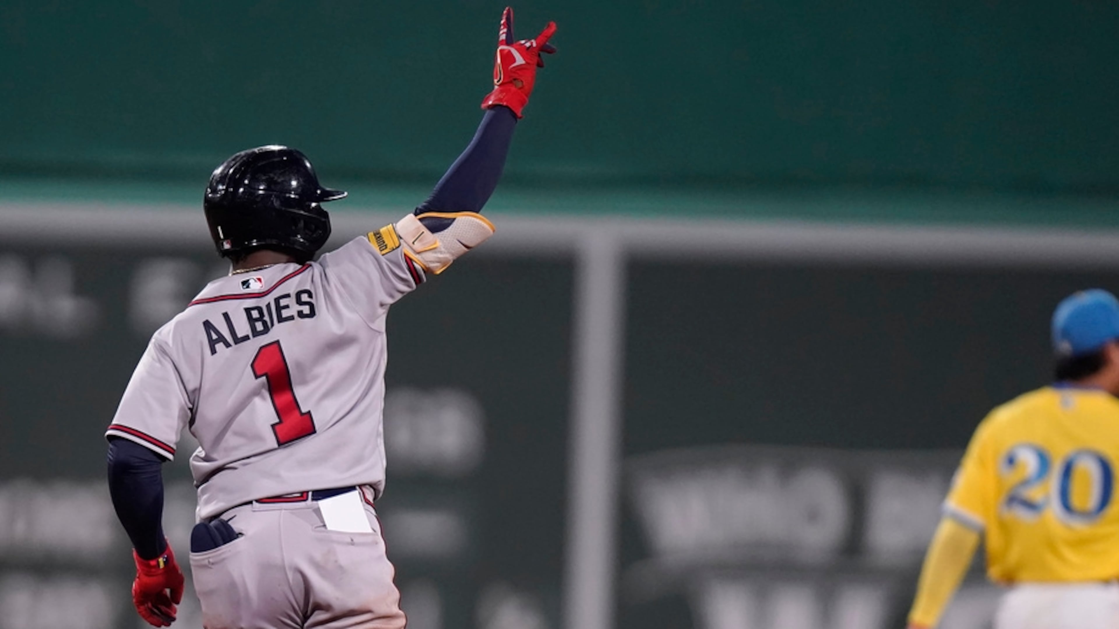 Atlanta Braves' Ozzie Albies (1) celebrates as he runs the bases past Boston Red Sox's Yu Chang (20) after hitting a three-run home run in the sixth inning of a baseball game, Wednesday, July 26, 2023, in Boston. (AP Photo/Steven Senne)
