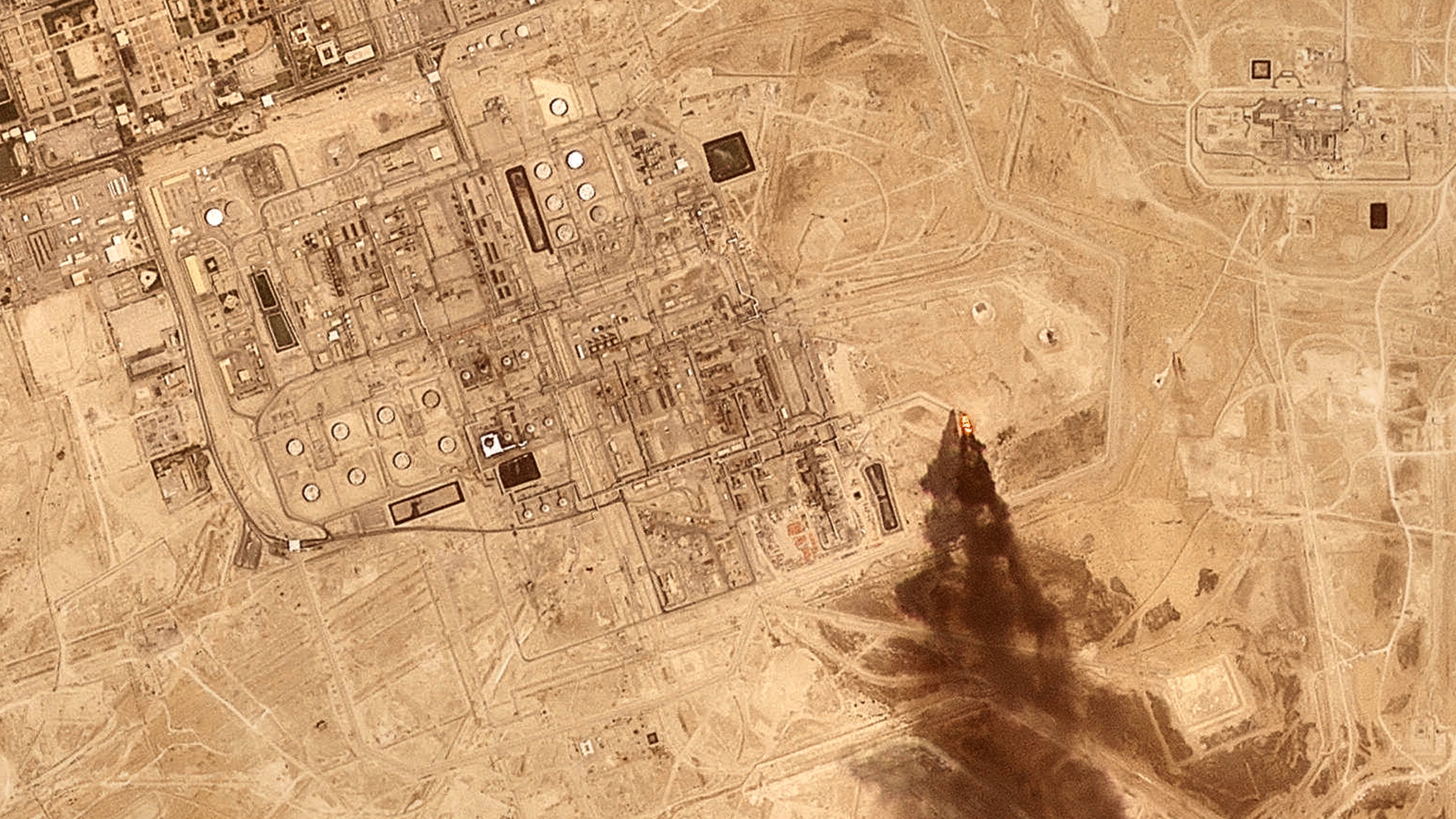 This satellite image provided by Planet Labs PBC on July 27, 2026 shows smoke rising from the Saudi Aramco oil processing facility in Abqaiq, Saudi Arabia, 2026. (Planet Labs PBC via AP)