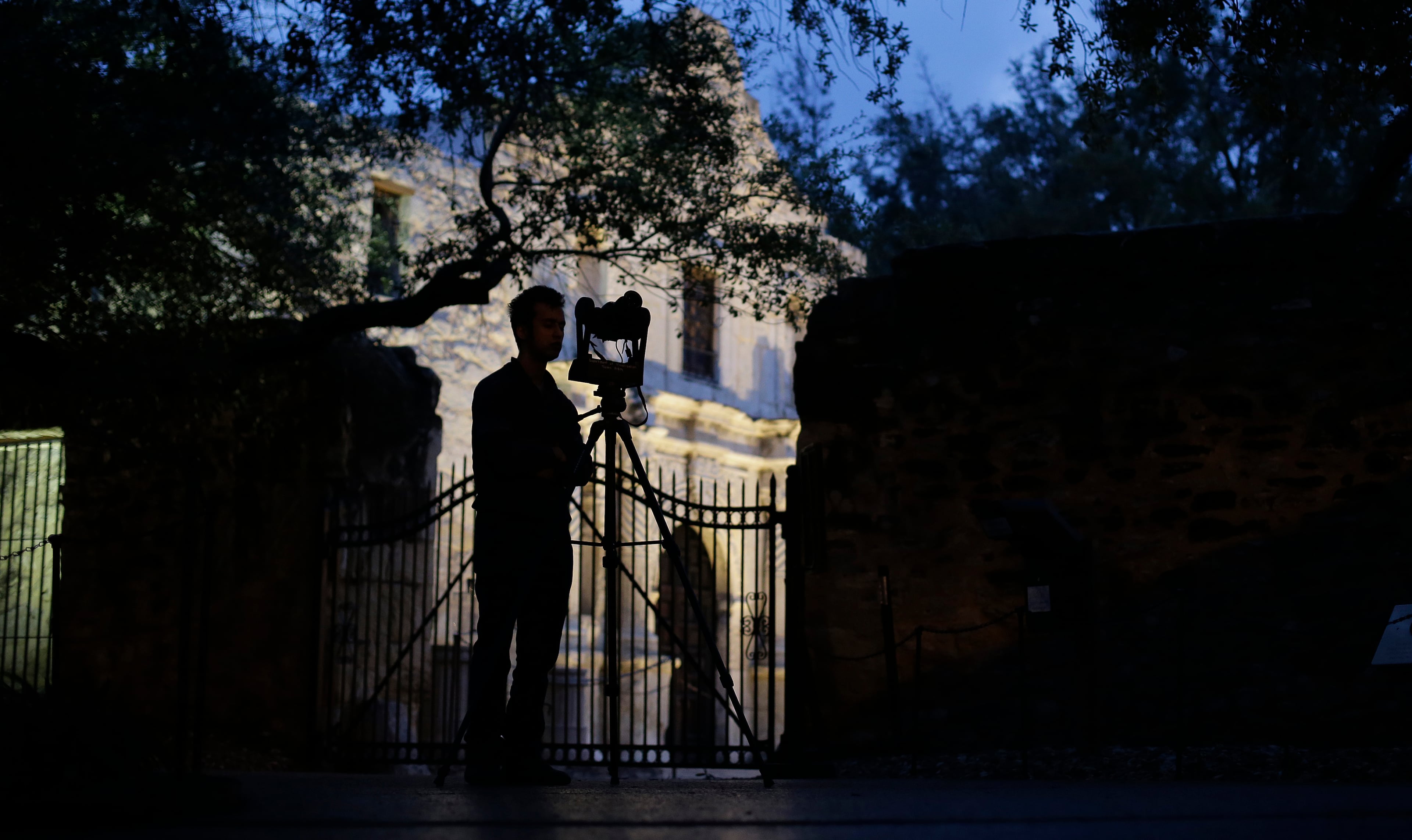Soheil Hamideh is silhouetted against the Alamo as he uses a camera to record images of the Alamo long barracks, Thursday, Jan. 9, 2014, in San Antonio. Hamideh is part of a team assembling digital two- and three-dimensional highly defined photos and laser images as part of a nearly 2-year-long project to help aid in preservation of the famous shrine to Texas independence and ensure future generations will be able to remember the Alamo.