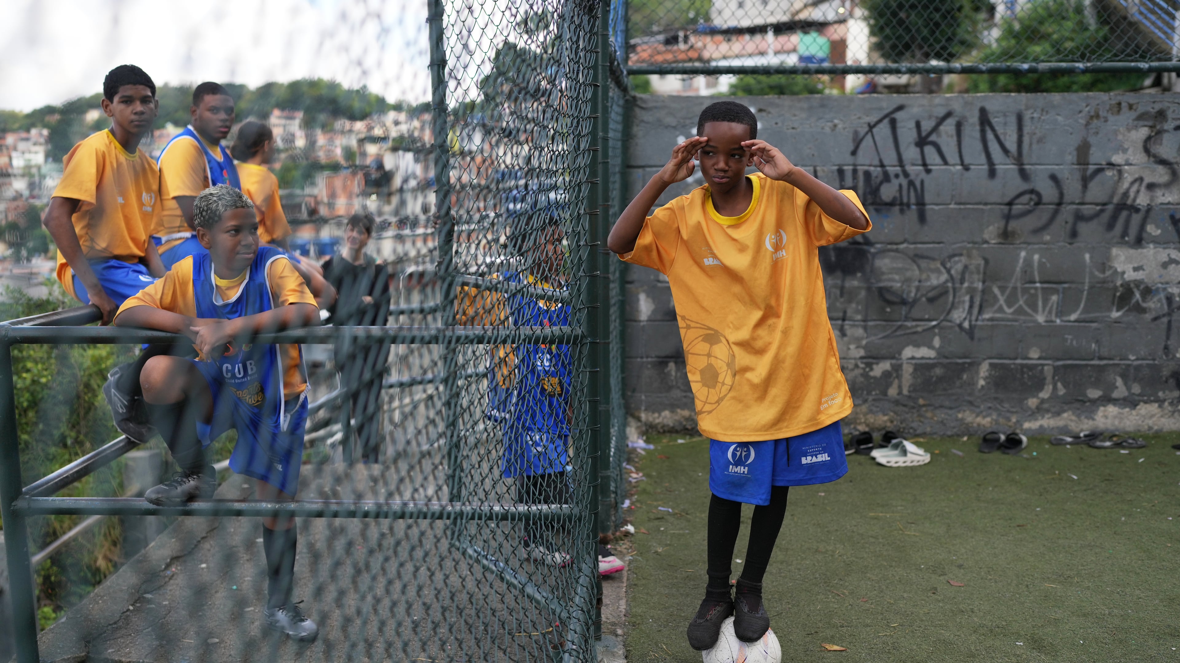 Luis Gustavo balances on a ball during a soccer training session organized by the Street Child United Brazil social project in the Complexo da Penha favela of Rio de Janeiro, Wednesday, June 3, 2026. (AP Photo/Silvia Izquierdo)