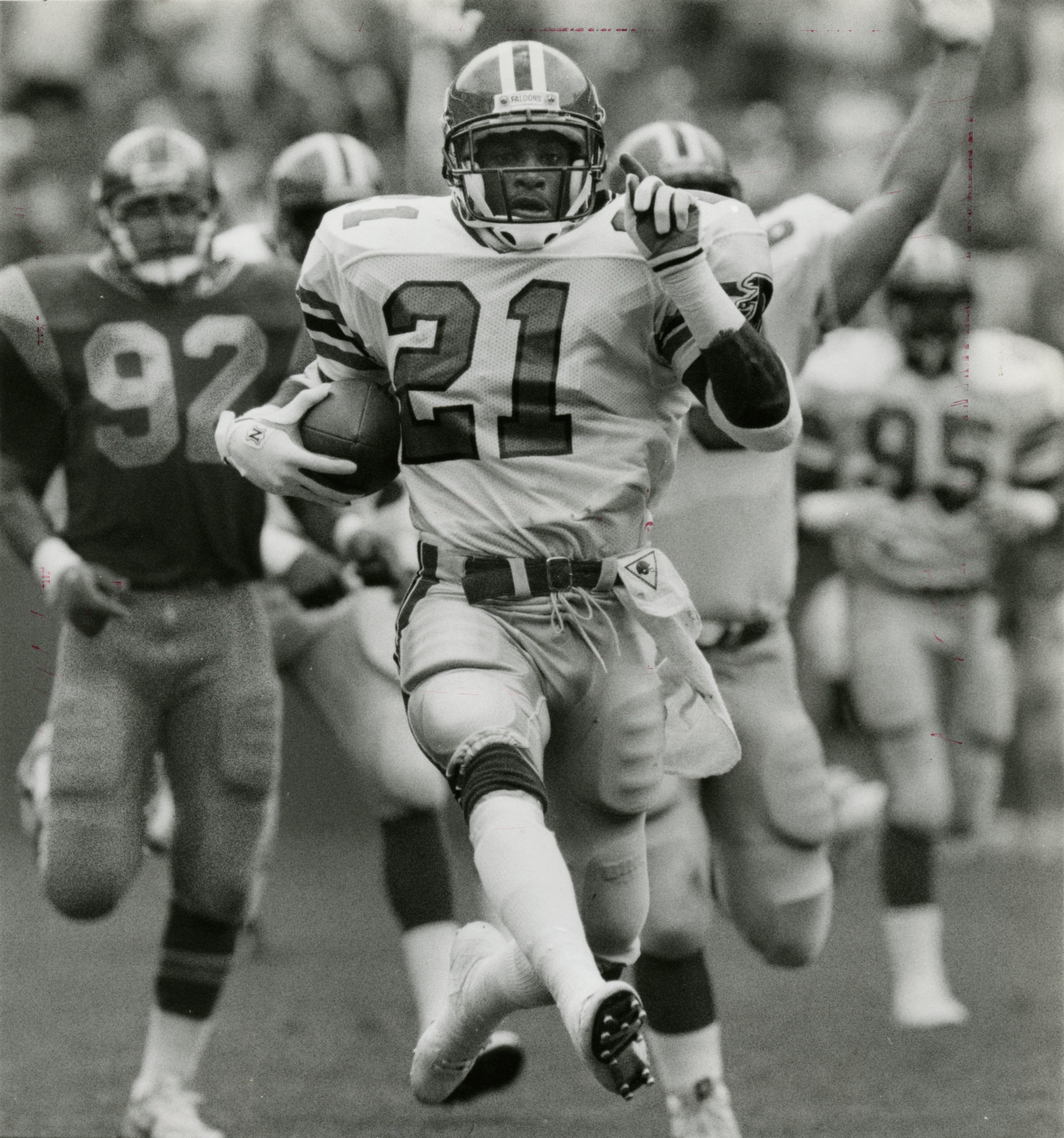 Newspaper assignment sheet attached to verso of print identifies the photographer (Wm Berry) and date (890910): "Deion Sanders scores on a 68yd punt return." Newspaper caption attached to assignment sheet: "Big-play guy: Deion Sanders has scored touchdowns as a cornerback, punt returner, kickoff returner and part-time receiver in his NFL career." Caption date-stamped "Mon May 30 1994 J C.