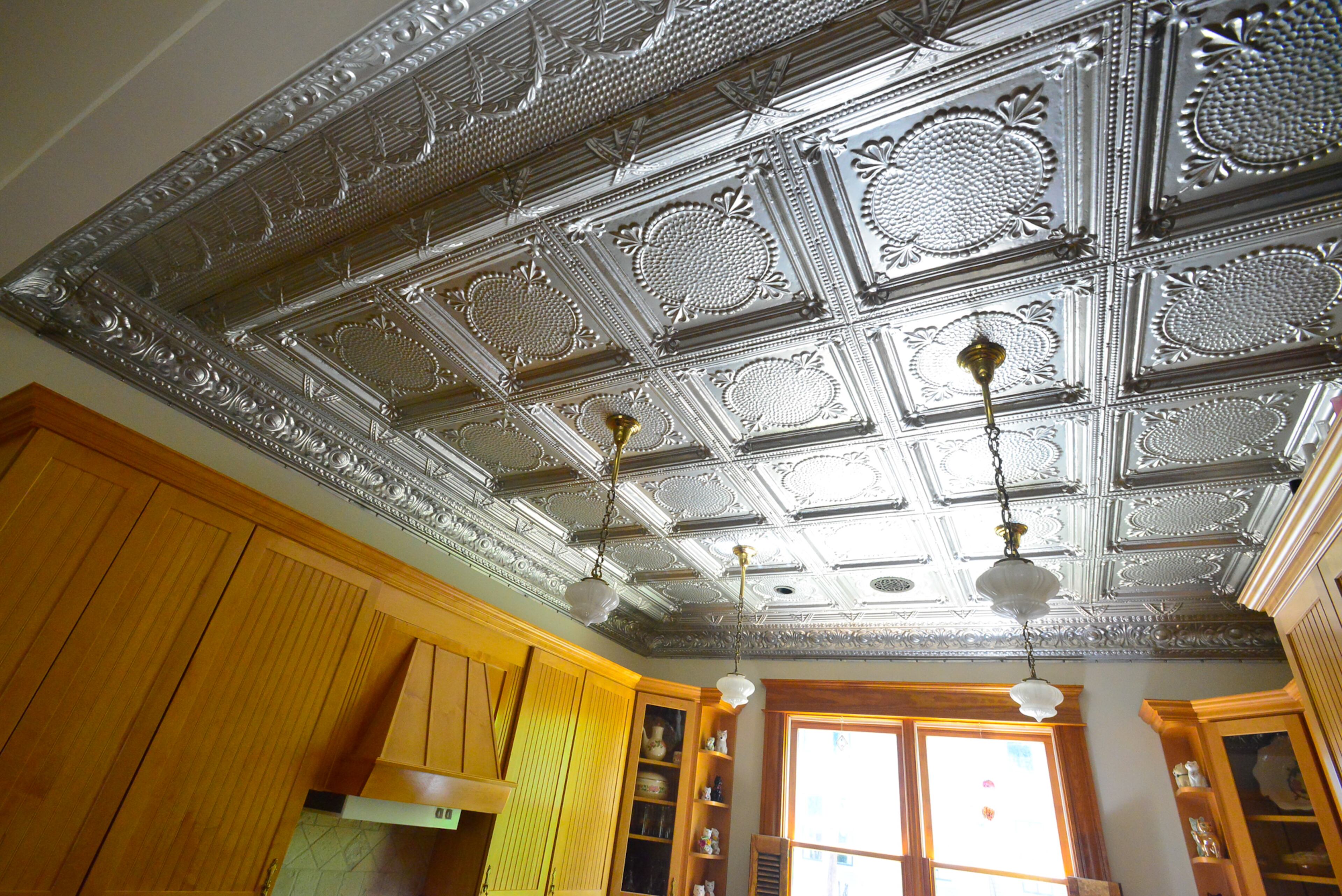 For the kitchen ceiling, homeowners Mike and Carolyn Dufano ordered tin-plated steel panels in a Victorian print from W. F. Norman Corp., and added a clear finish. They cut the metal and installed the tin ceiling in 2009.