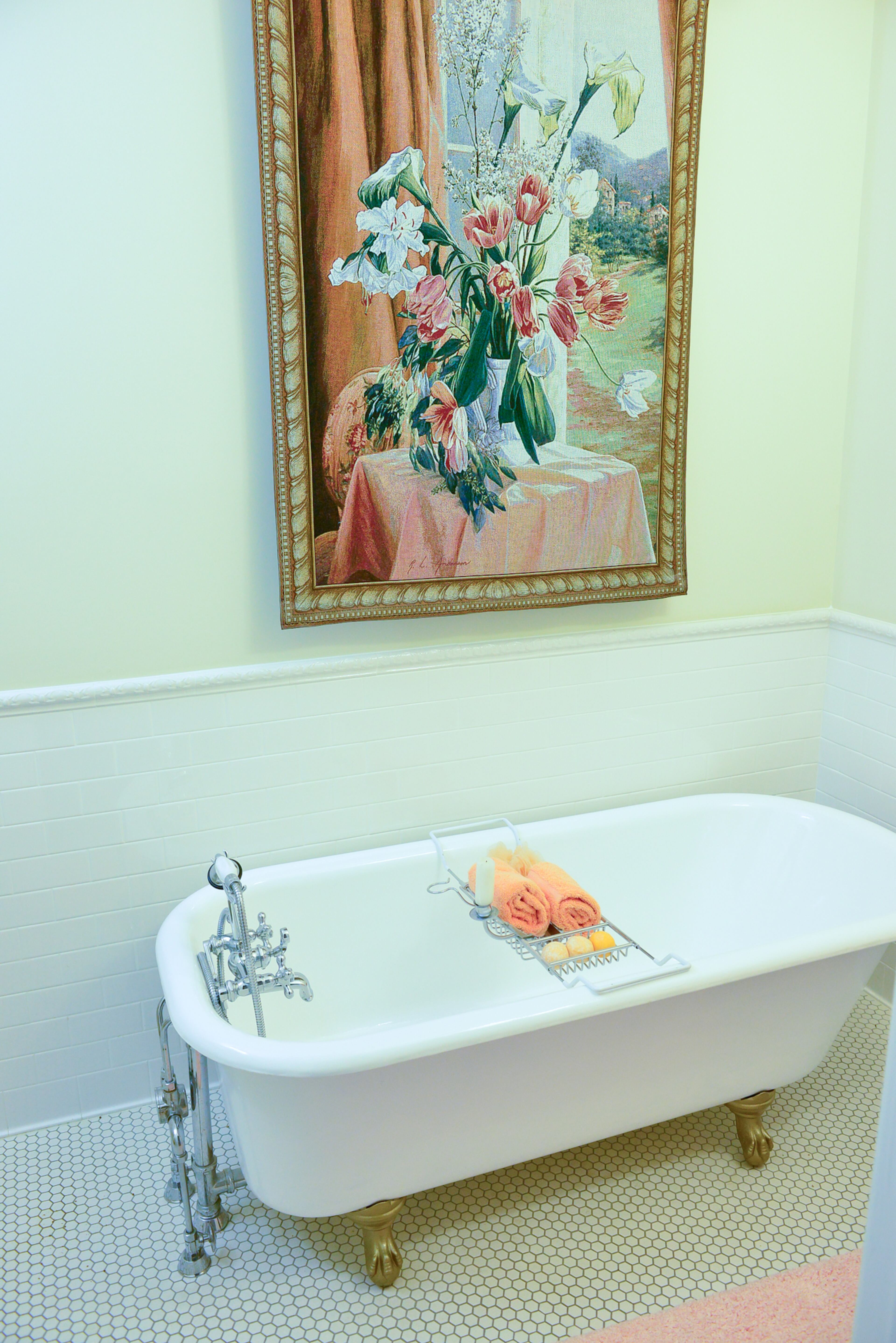 An early 1900s cast iron tub - found in an old barn - was placed in the guest bathroom of Mike and Carolyn Dufano's home in Grant Park. The tub was hoisted up the unfinished stairway by Mike and others, and moved into the bathroom, which has hexagon-shaped tile floors and tapestry for decor.