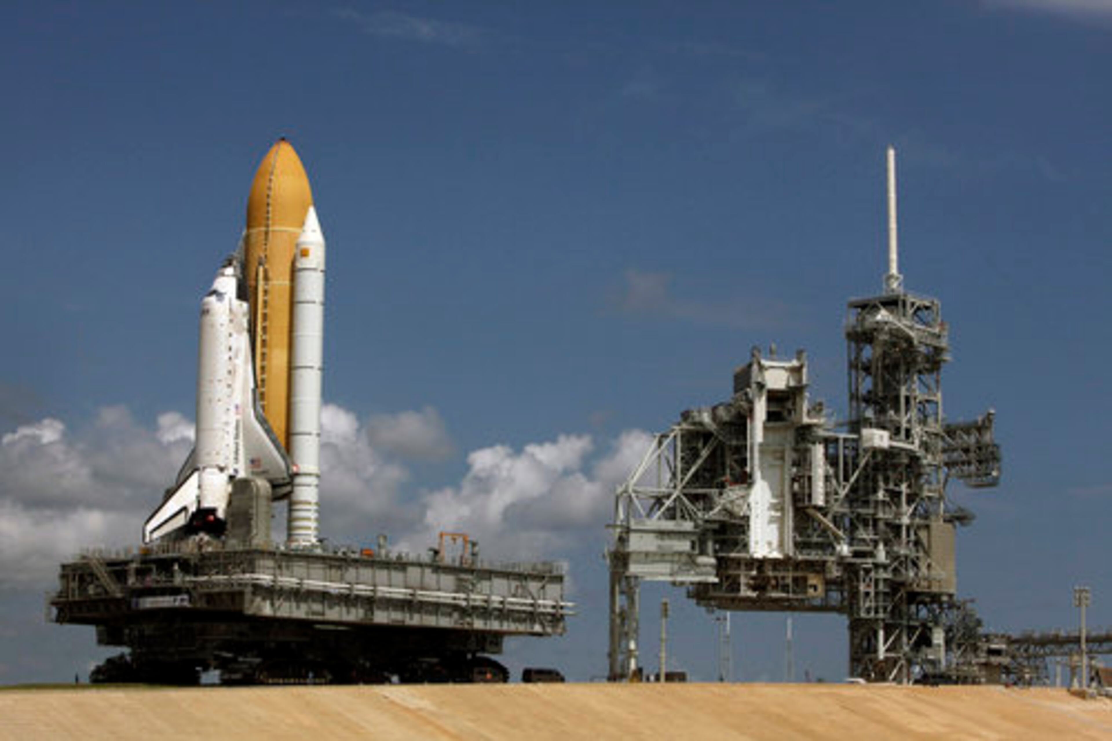 NASA has uses crawler-transporters - a pair of tracked vehicles - to transport the orbiter from the assembly building to the launch pad. The orbiter is transported the 3.5 miles at a maximum speed of 1 mile per hour.