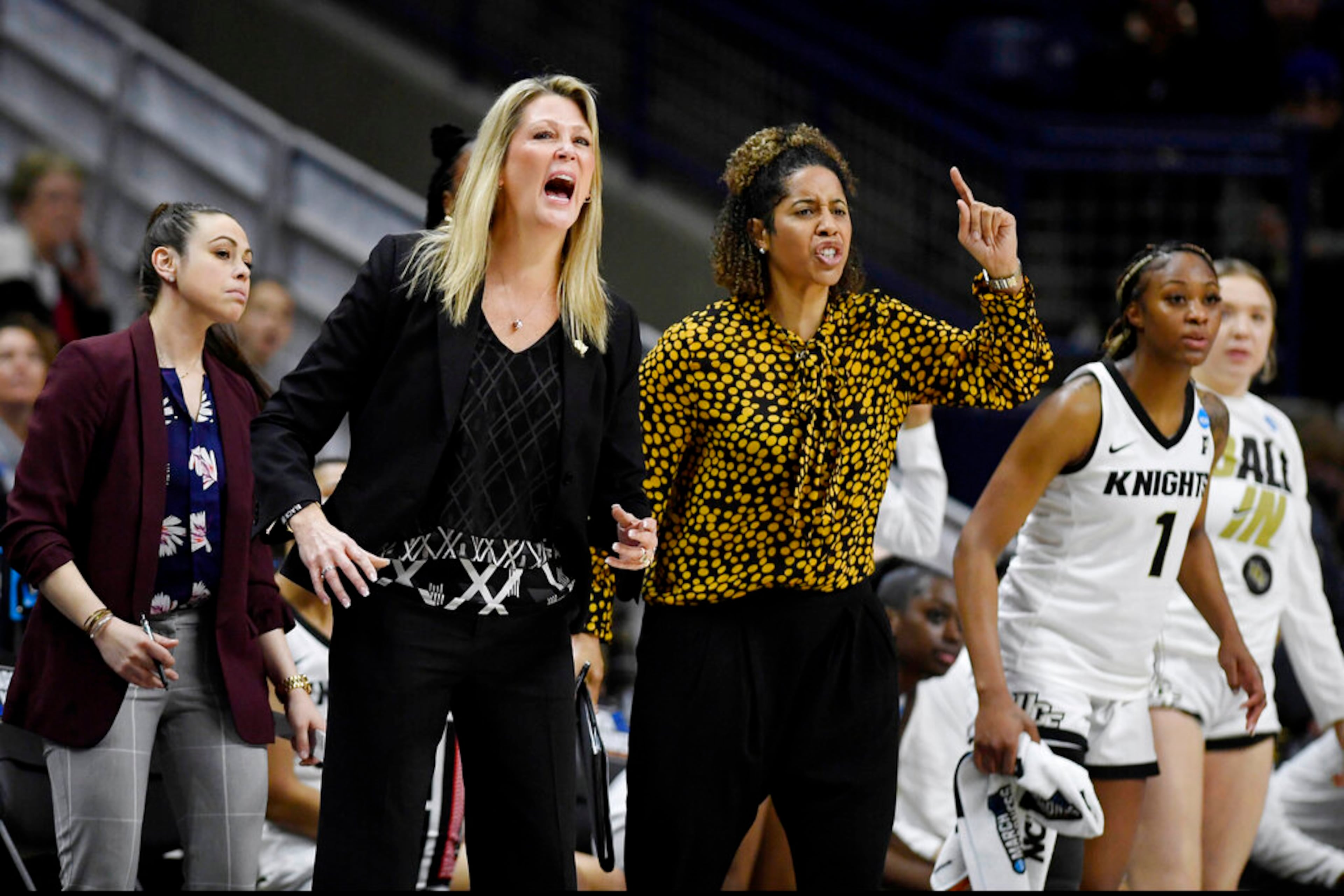 Central Florida head coach Katie Abrahamson-Henderson, left, and assistant coach Nykesha Sales react during the second half of a first-round women's college basketball game against Florida in the NCAA tournament, Saturday, March 19, 2022, in Storrs, Conn. (AP Photo/Jessica Hill)