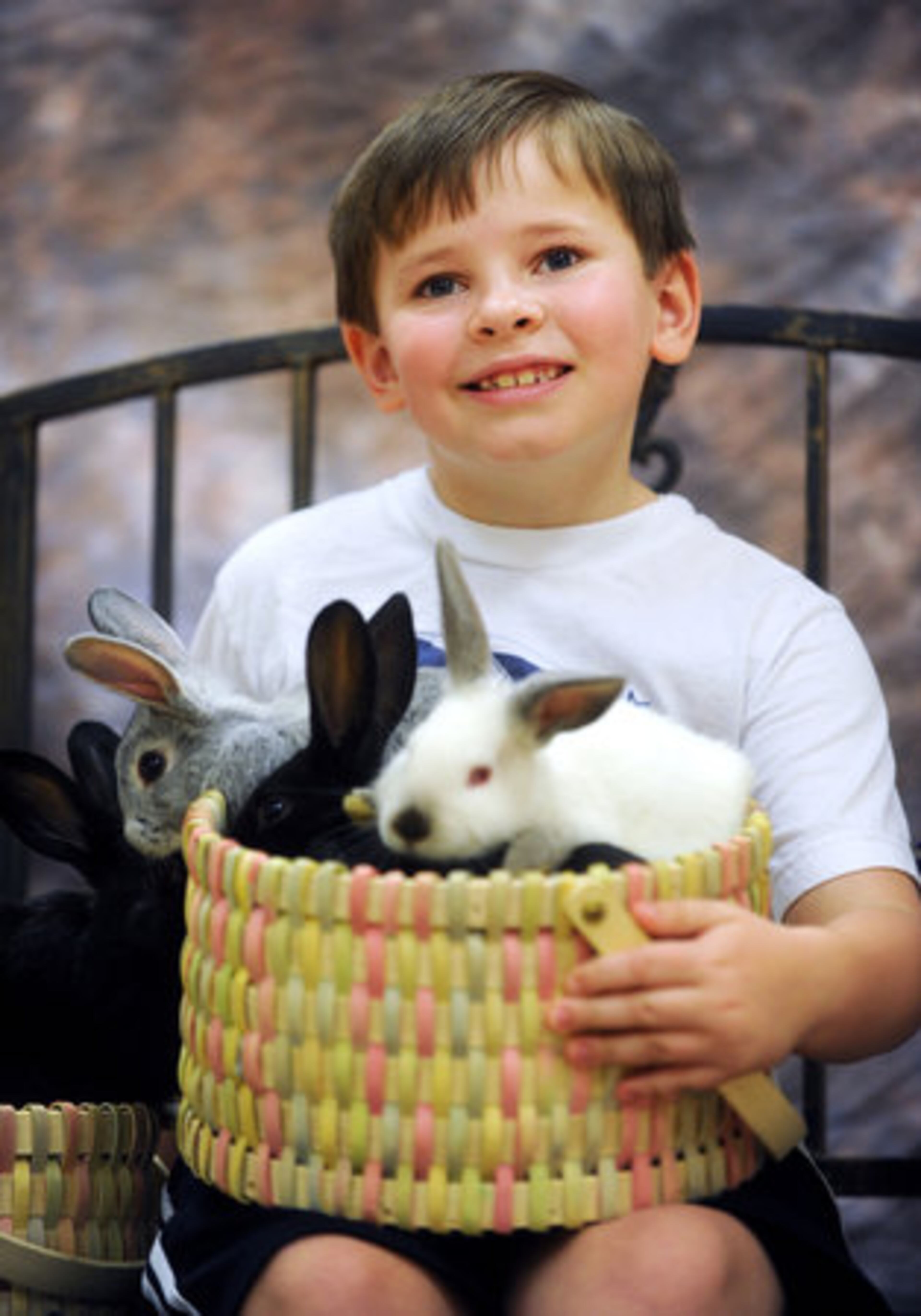 Hayden Mitchell, 8, has his photo taken with live bunnies in advance of Easter at the Learning Express in Alpharetta Saturday, April 9, 2011.