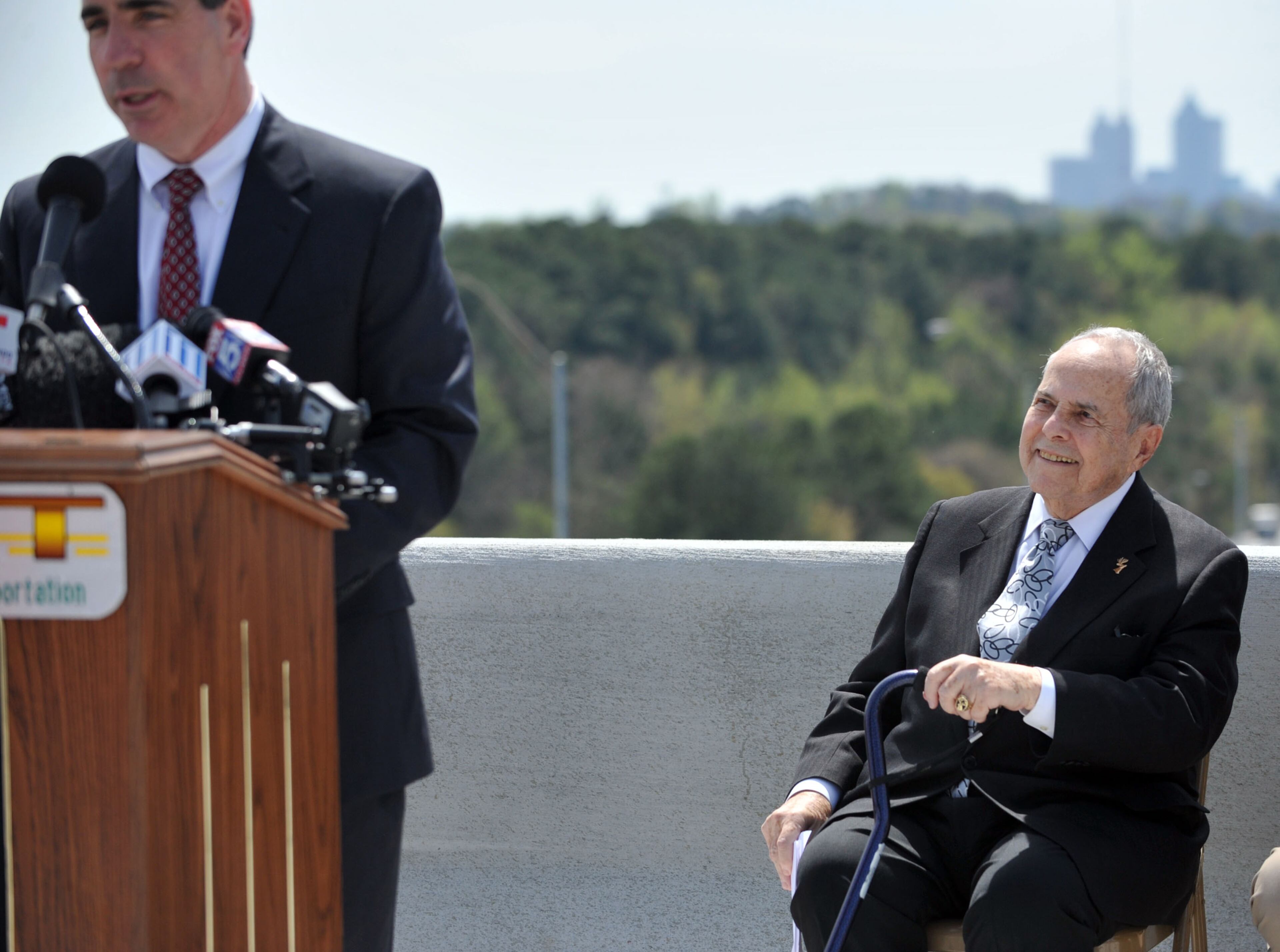 Former Atlanta Mayor Sam Massell listens to remarks by GDOT Commissioner Keith Golden. Governor Nathan Deal and other state and local leaders conducted a brief ribbon-cutting celebration of the opening of the new flyover ramps Wednesday, April 2, 2014. The ramps provide I-85 southbound traffic with direct access to GA 400 northbound and also give GA 400 southbound motorists a direct ramp to I-85 northbound.