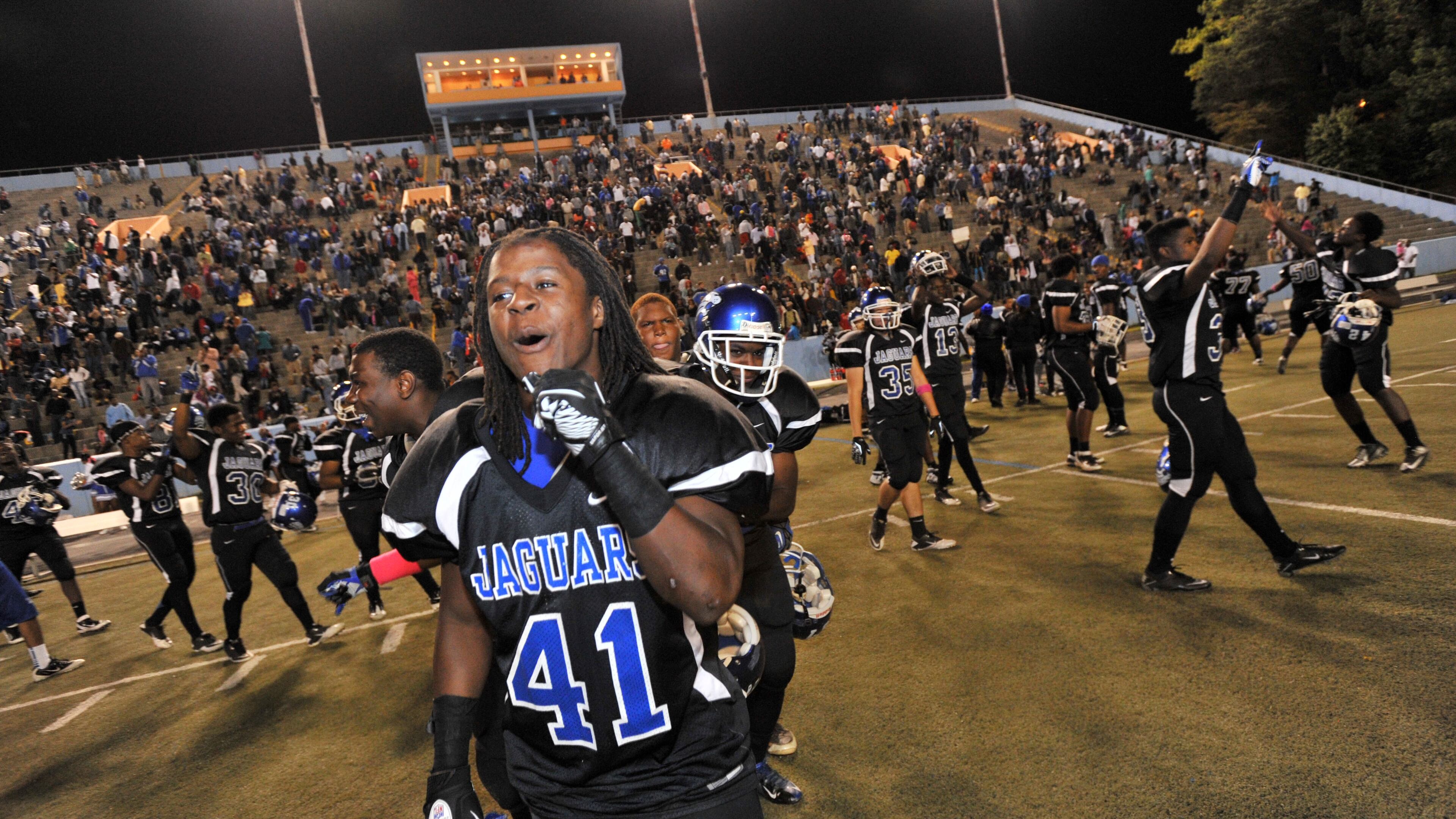Stephenson's Kyseem Tillman (41) and other players celebrate team's 13-6 victory over Tucker in the battle of DeKalb County powers.