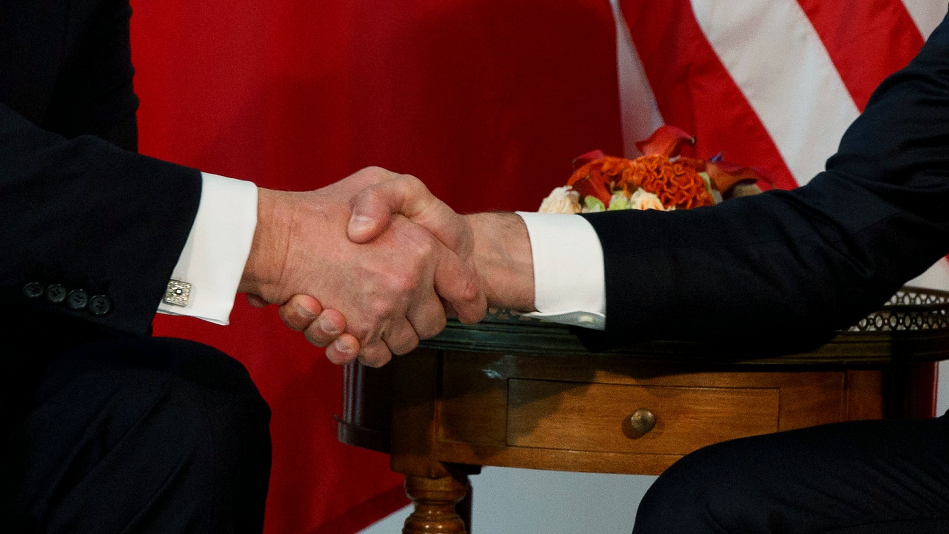 FILE - President Donald Trump shakes hands with French President Emmanuel Macron during a meeting at the U.S. Embassy, May 25, 2017, in Brussels. (AP Photo/Evan Vucci, file)