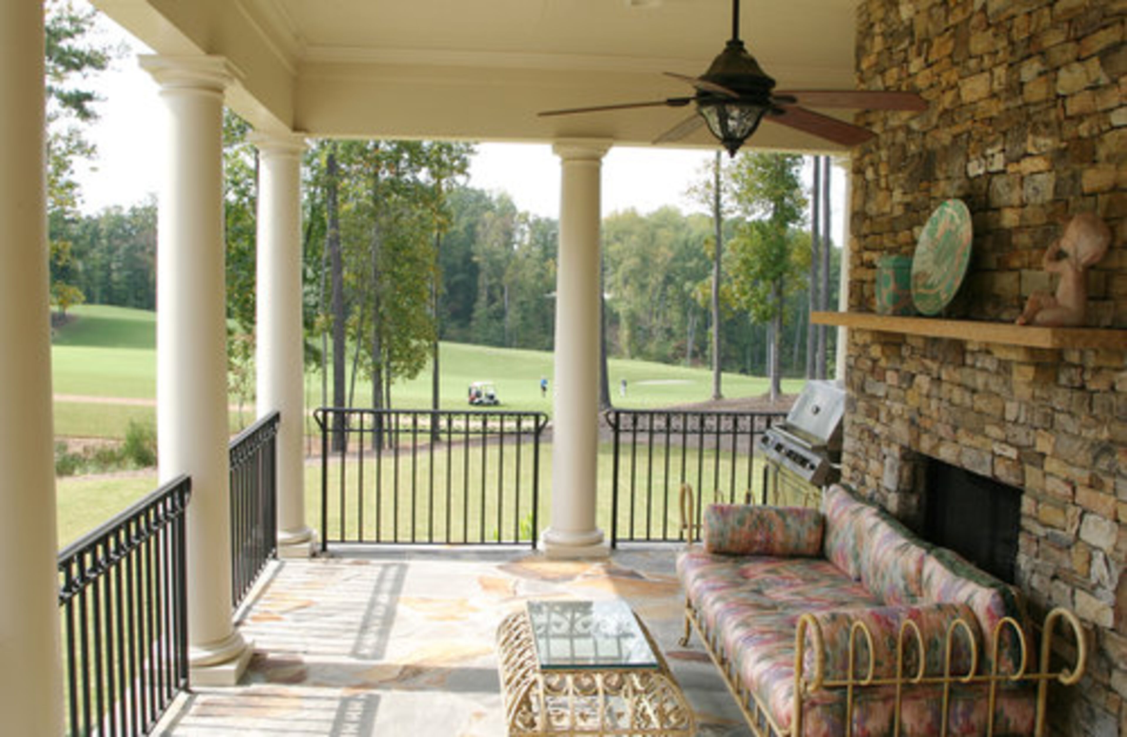 "The covered porch is my second kitchen," declares Tom. The home has a view of the first hole of the golf course that is the centerpiece of the Echelon gated community.