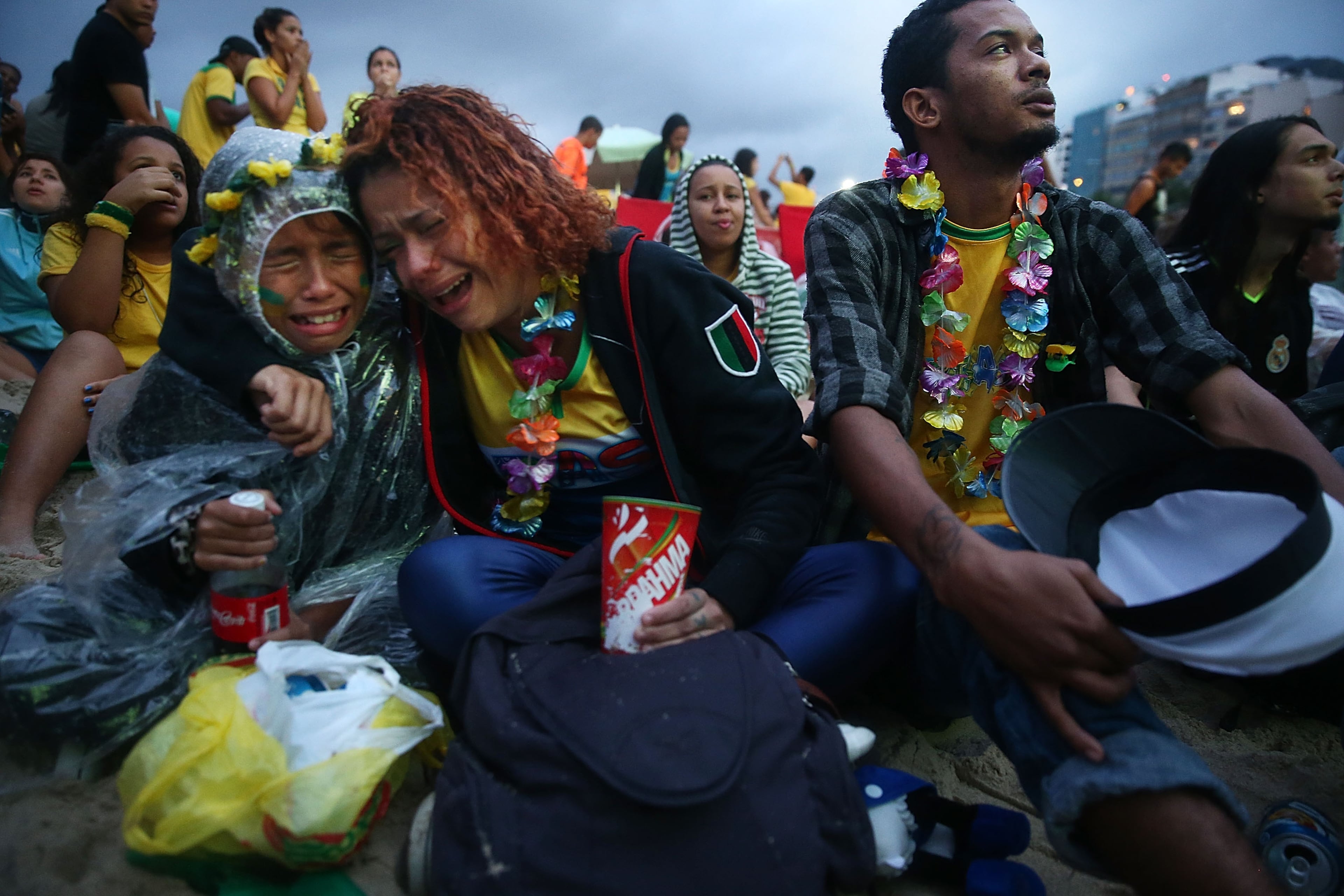 Brazil fans are devastated while watching the first half on Copacabana Beach during the 2014 FIFA World Cup semi-final match between Brazil and Germany on July 8, 2014 in Rio de Janeiro, Brazil. (Photo by Mario Tama/Getty Images)