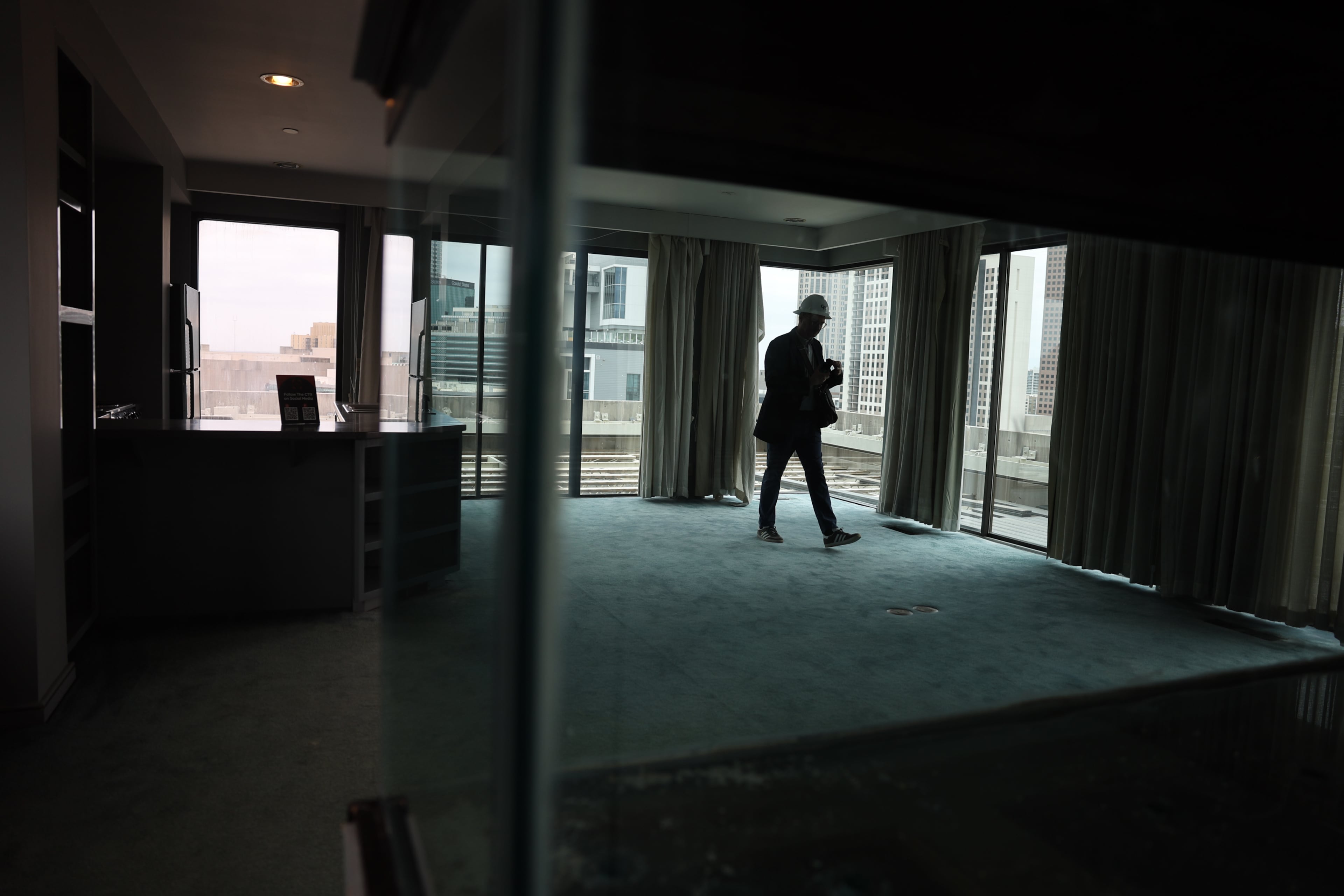 A person is silhouetted inside Ted Turner’s former private residence inside The Center, formerly CNN Center, in Atlanta on March 30, 2026. (Arvin Temkar/AJC)