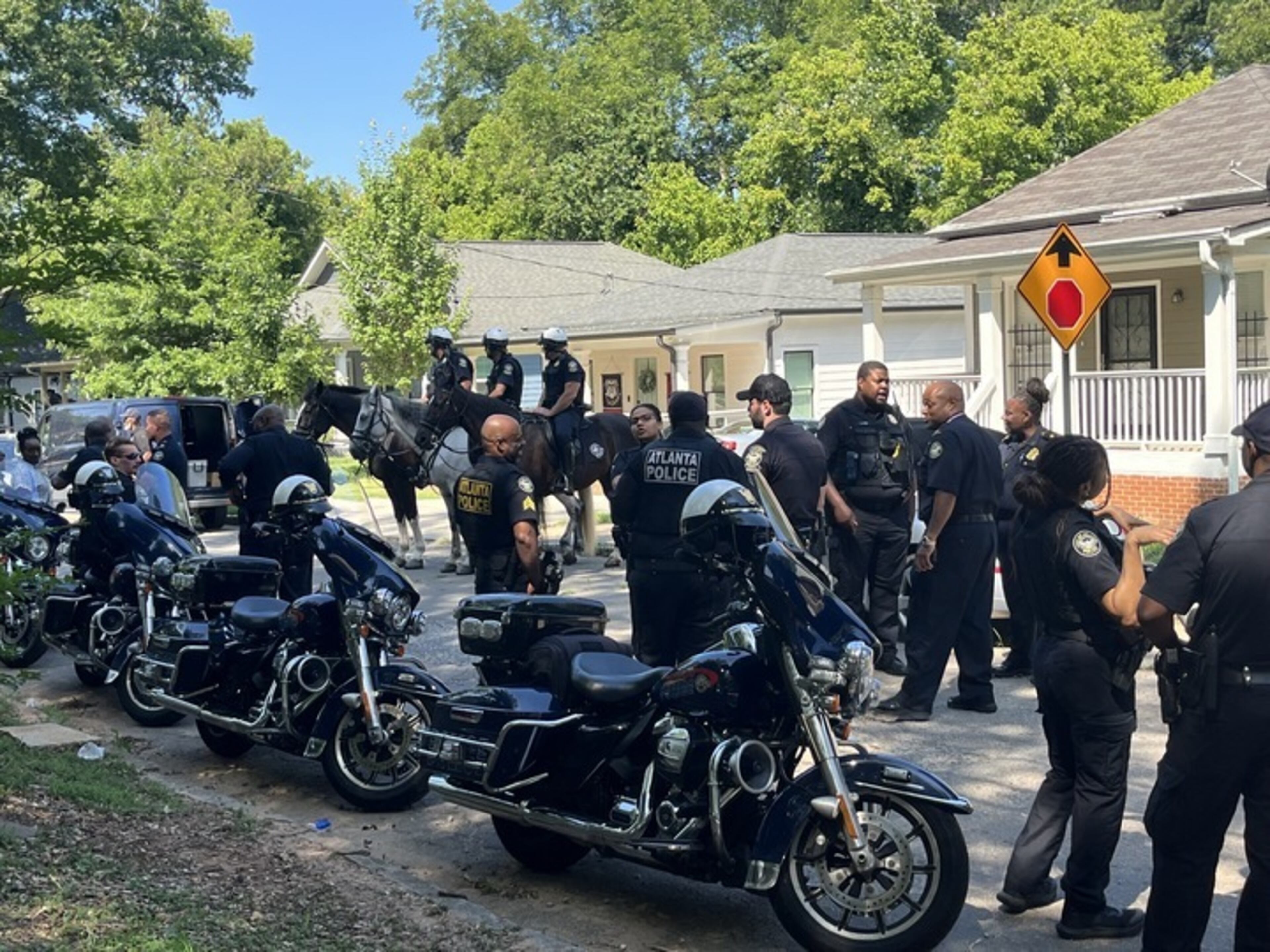 Police officers spoke to locals in the area of Sparks Street in southwest Atlanta on Friday about the fatal shooting of two teenagers that happened July 2. Officials canvassed the neighborhood to raise awareness and try to learn information that could aid in the homicide investigation.