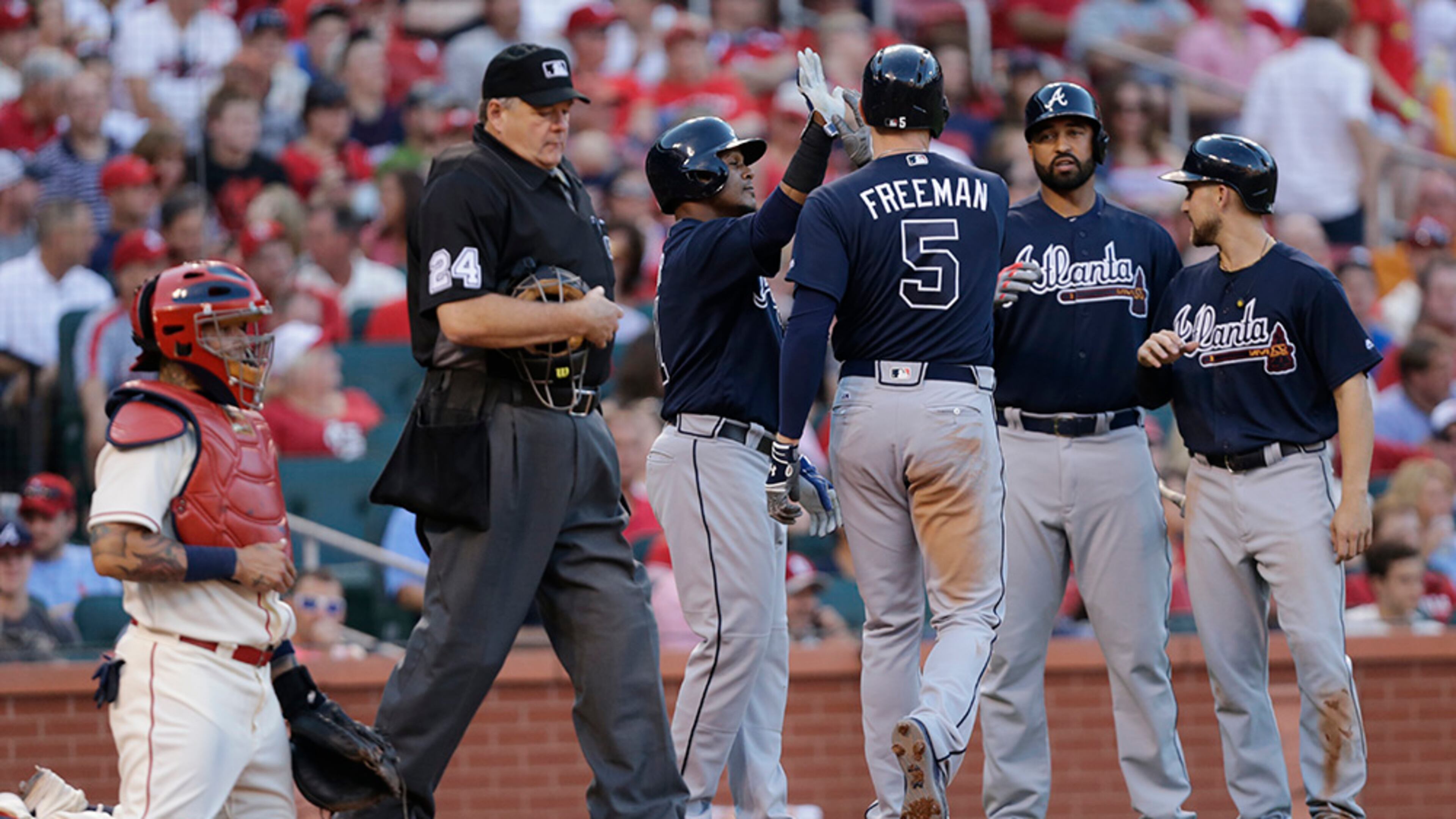 Braves’ Freddie Freeman (5) celebrates with teammates after hitting a three-run home run as home plate umpire Jerry Layne (24) and St. Louis Cardinals catcher Yadier Molina look on in the third inning Saturday, Aug. 6, 2016, in St. Louis. (Tom Gannam/AP)