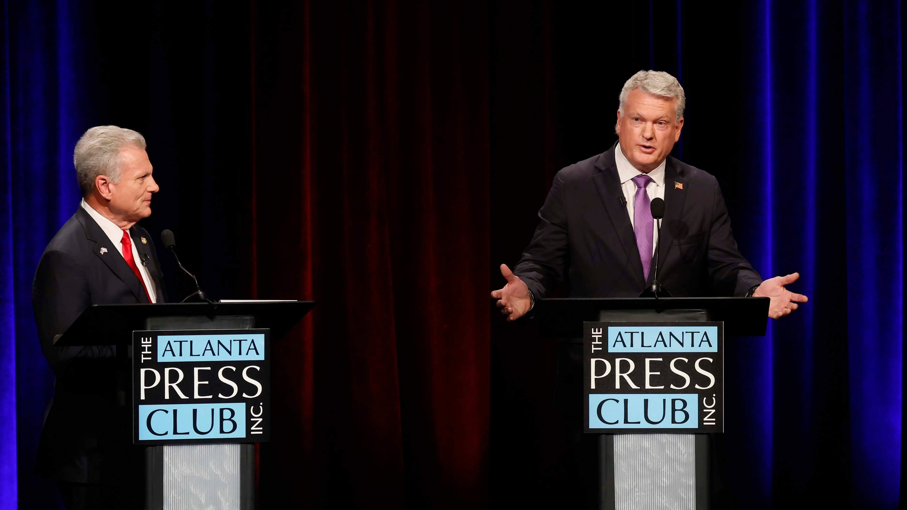 U.S. Rep. Mike Collins, R-Jackson, responds to a question from U.S. Rep. Buddy Carter, R-St. Simons Island, during the Atlanta Press Club's Republican Loudermilk-Young debate at Georgia Public Broadcasting in Midtown, Atlanta, on Sunday, April 26, 2026. (Miguel Martinez/Atlanta Journal-Constitution via AP)