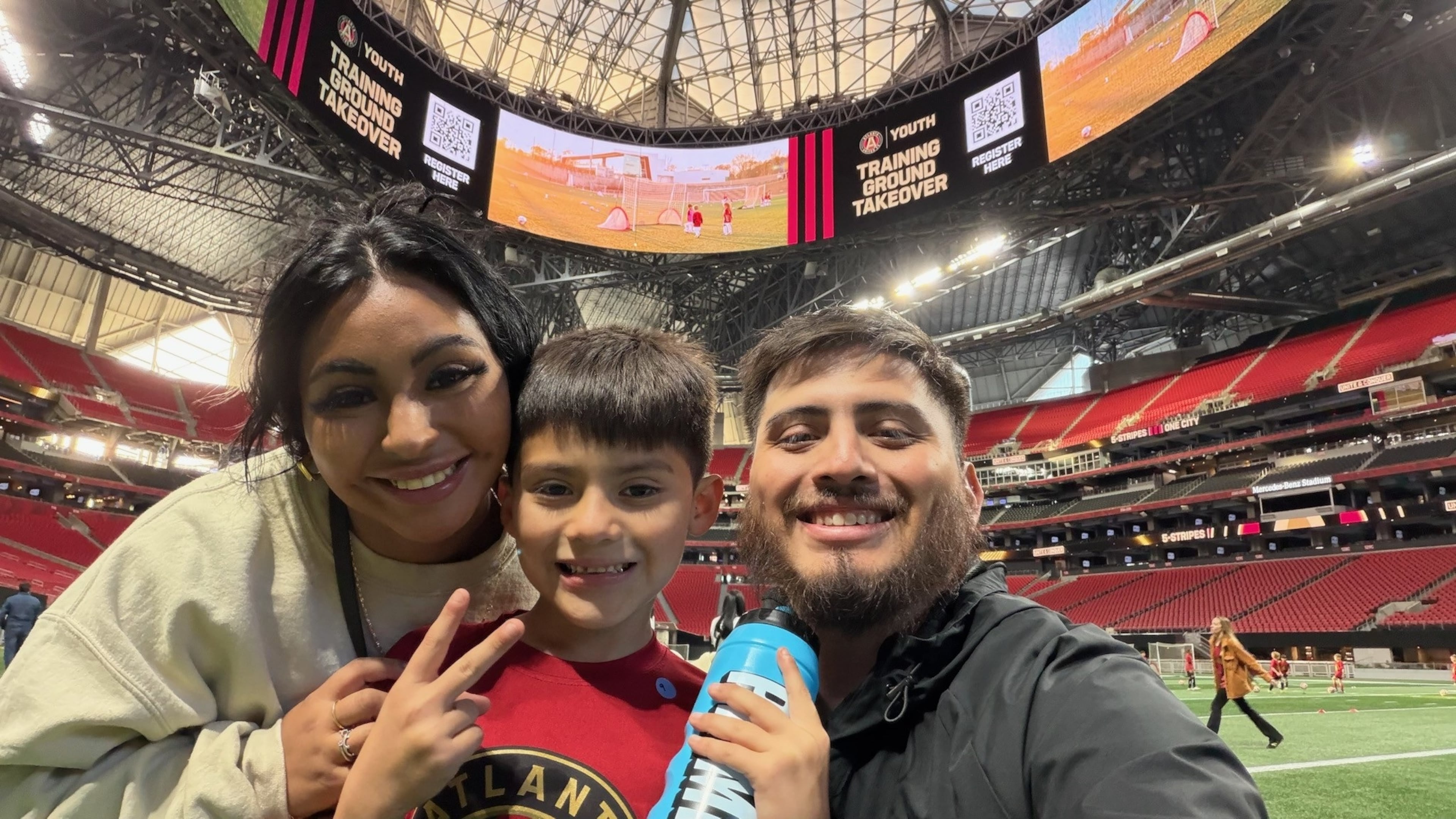 Stockbridge soccer fan Edgar Castillo with his wife, Yareli, and son Mateo at Mercedes-Benz Stadium. After Castillo was quoted in an Atlanta Journal-Constitution column expressing his disappointment that he was priced out of World Cup tickets, Atlanta sports marketing executive Vince Thompson read the column and offered to purchase tickets for Castillo and his family. (Courtesy of Edgar Castillo)